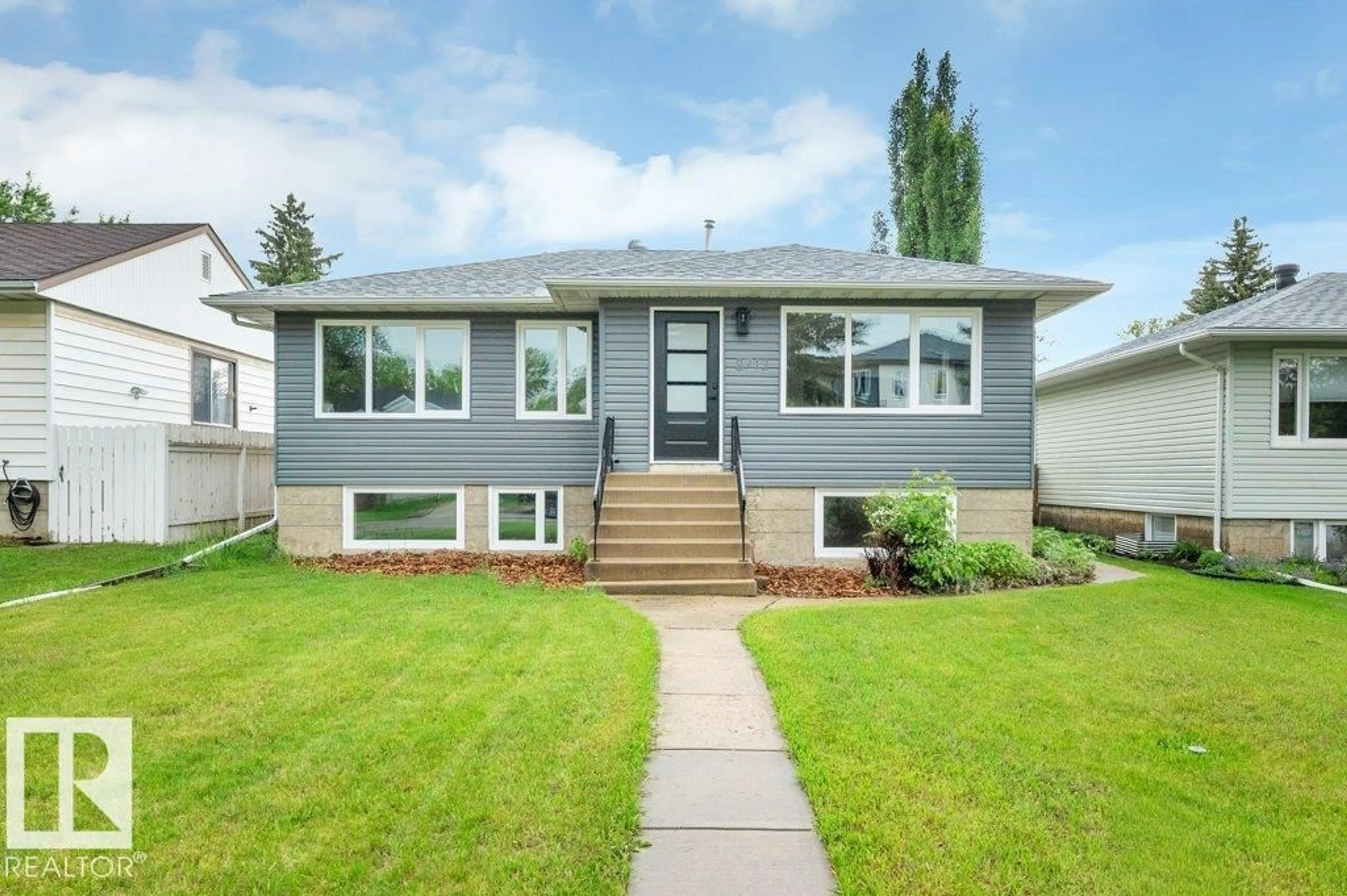 Home with vinyl exterior material, street for NW - 8712 89 AV, Edmonton Alberta T6C1N7