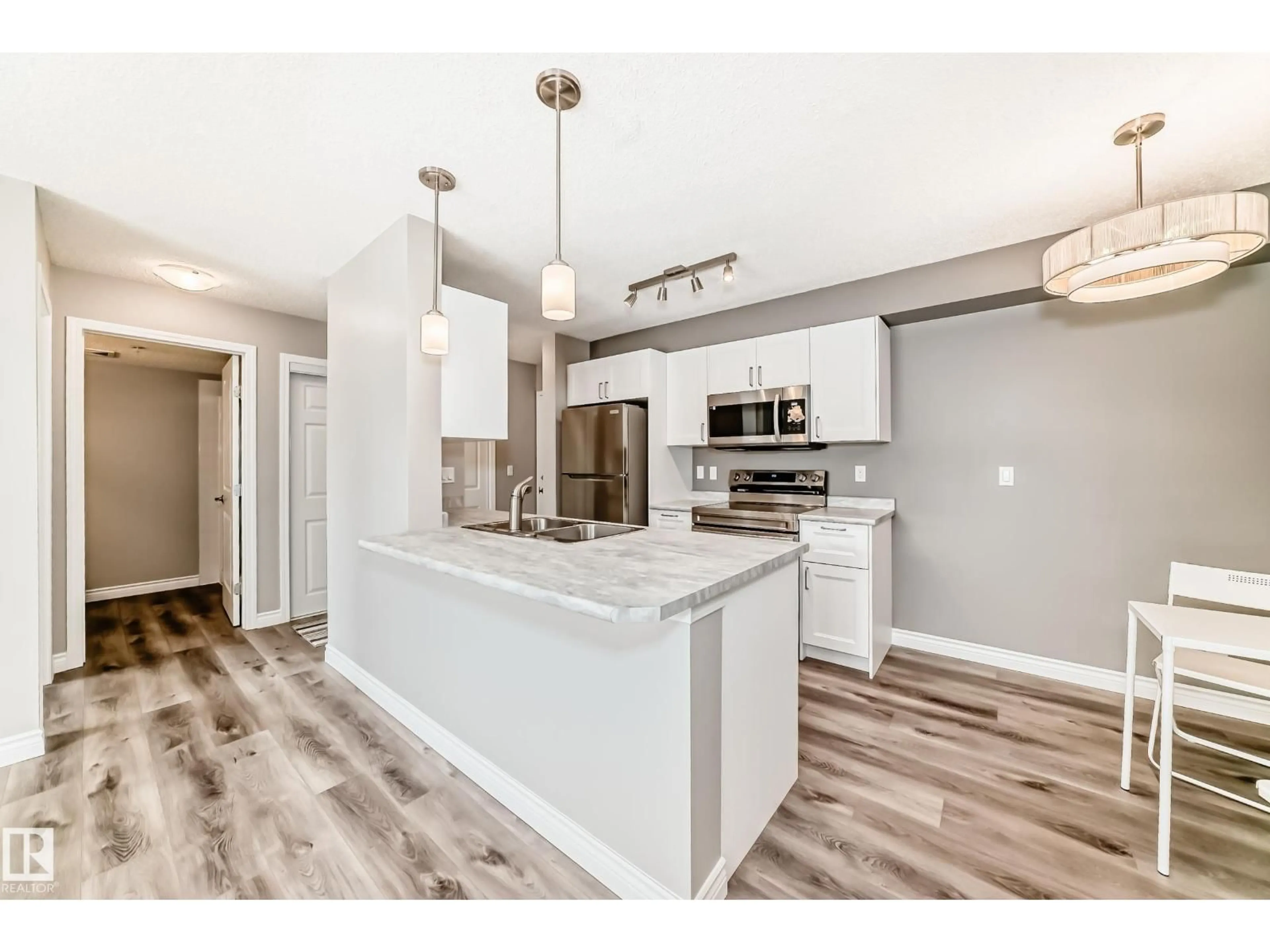 Open concept kitchen, wood/laminate floor for 318 - 13908 136 ST NW, Edmonton Alberta T6V1Y4