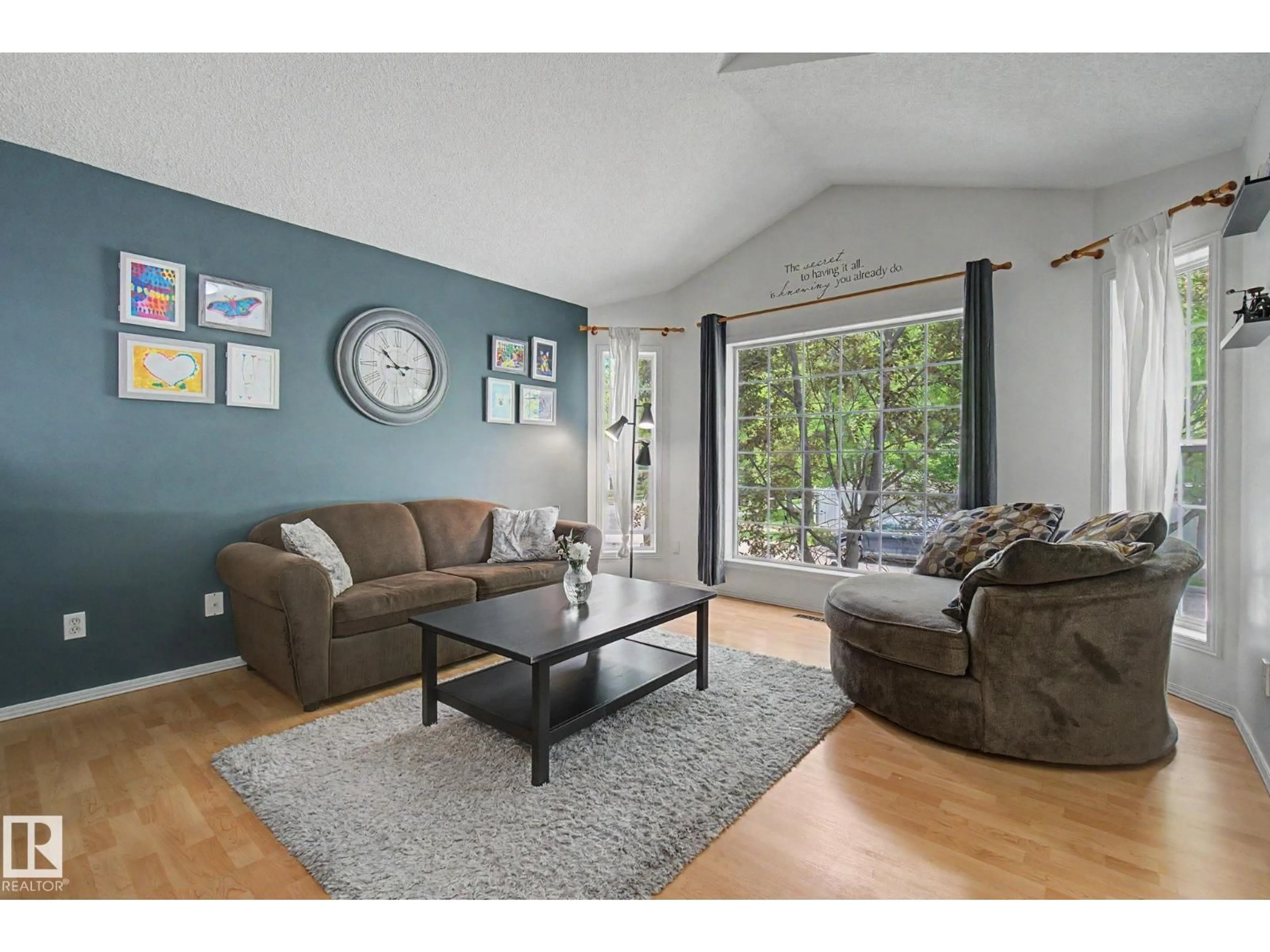 Living room with furniture, wood/laminate floor for 1622 TOMPKINS WD, Edmonton Alberta T6R2Y5