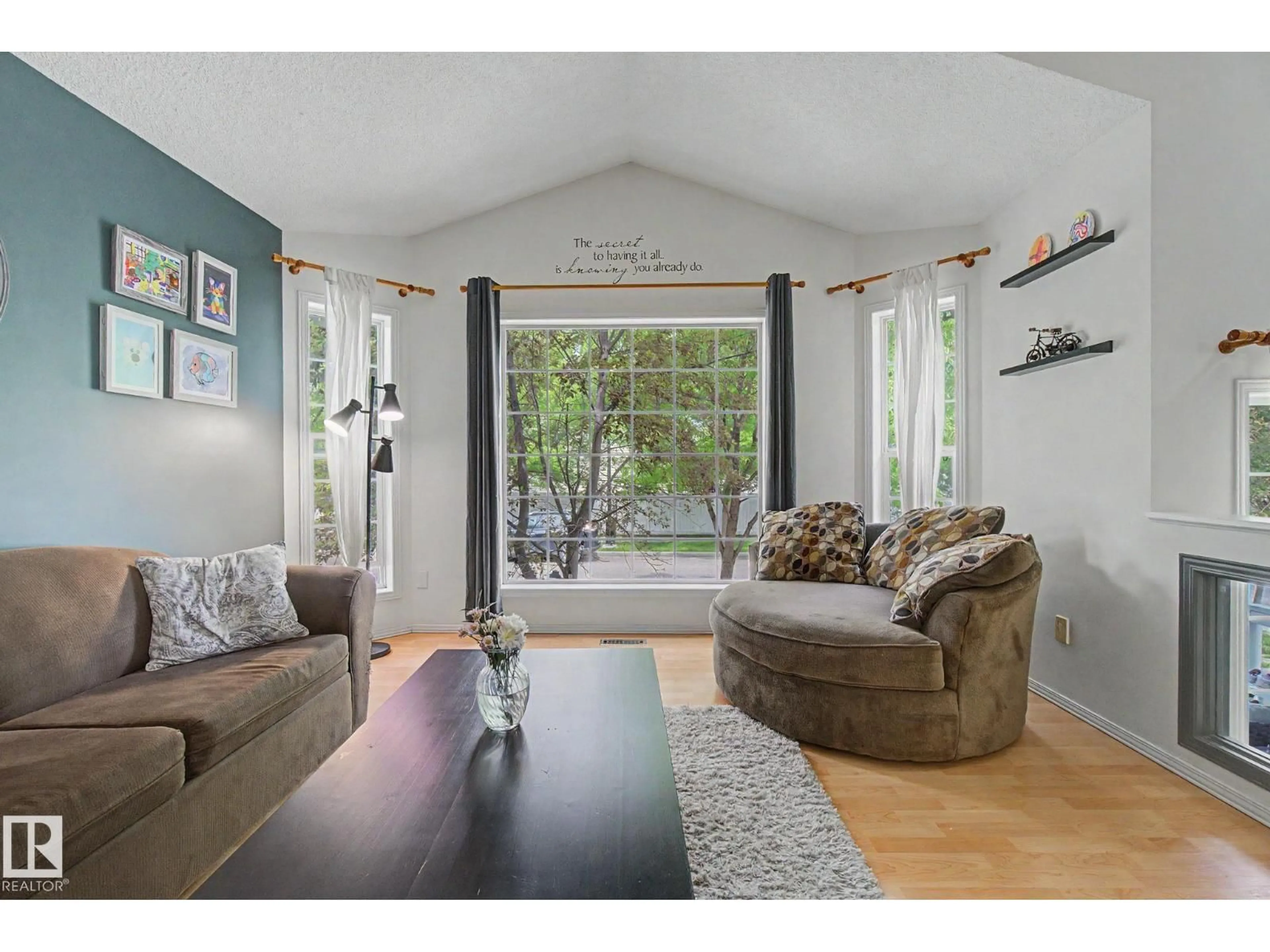 Living room with furniture, wood/laminate floor for 1622 TOMPKINS WD, Edmonton Alberta T6R2Y5