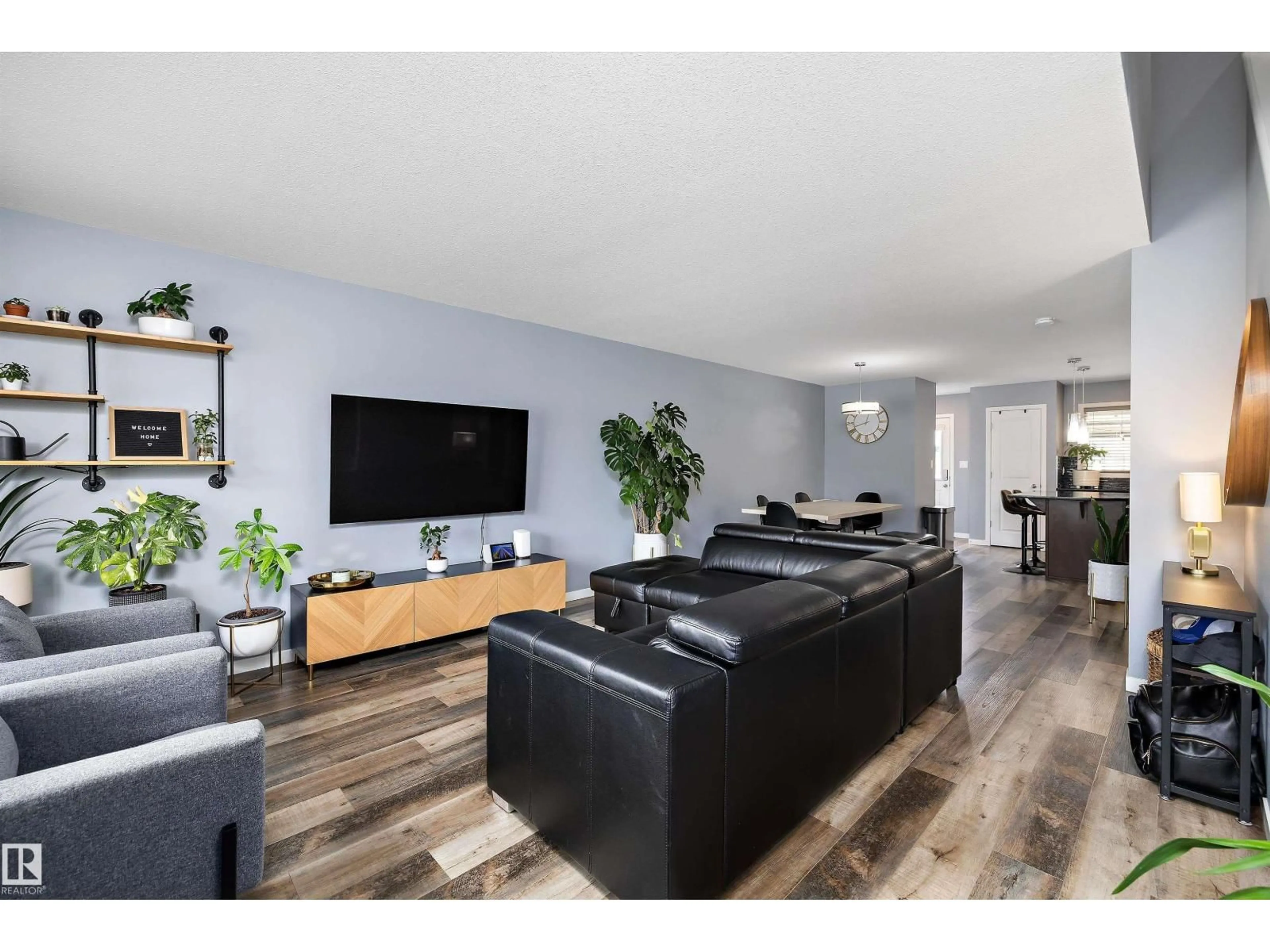 Living room with furniture, wood/laminate floor for 2833 CHOKECHERRY PL, Edmonton Alberta T6X2J8