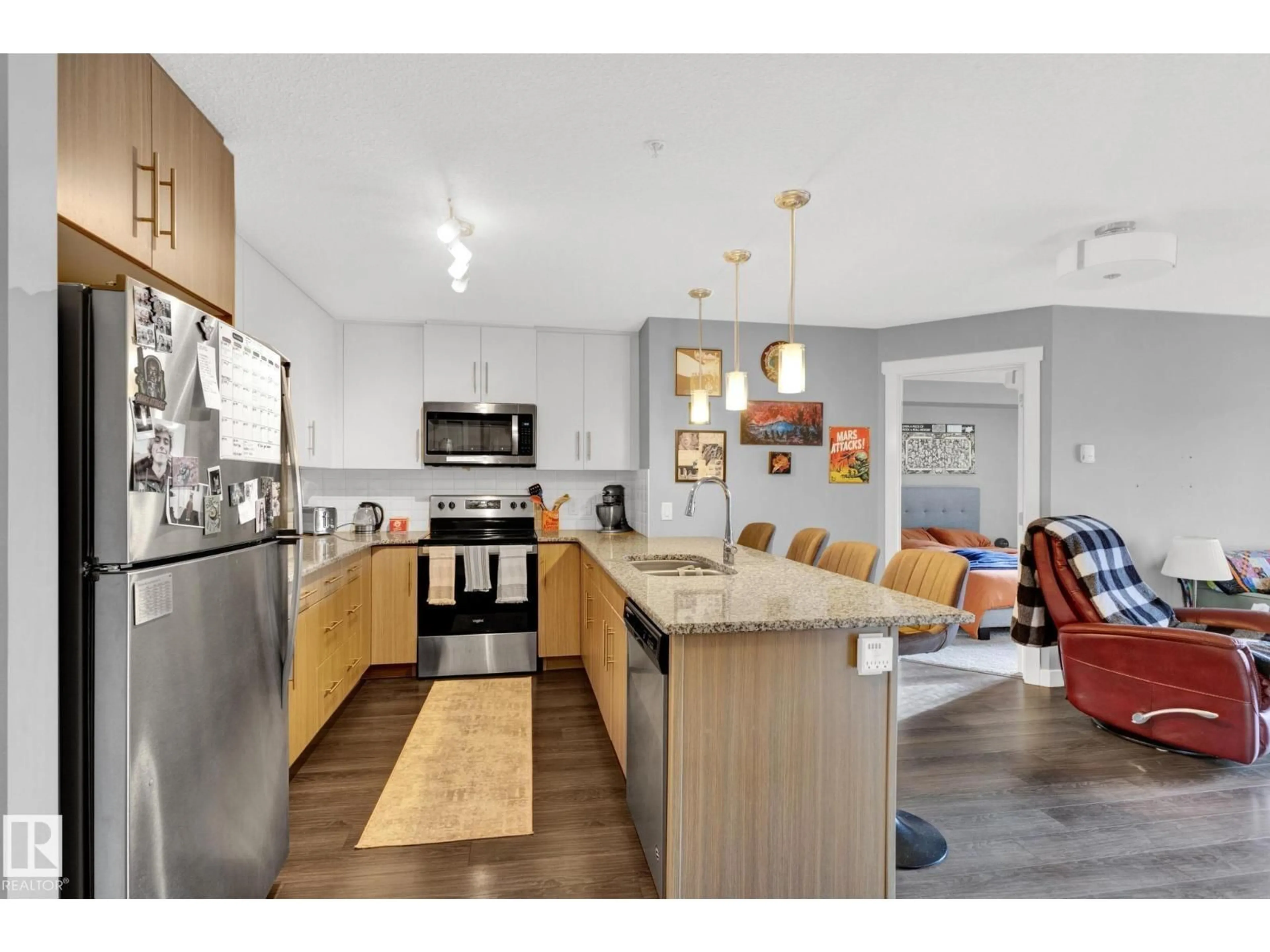 Open concept kitchen, wood/laminate floor for #305 - 3670 139 AV, Edmonton Alberta T5Y3N5