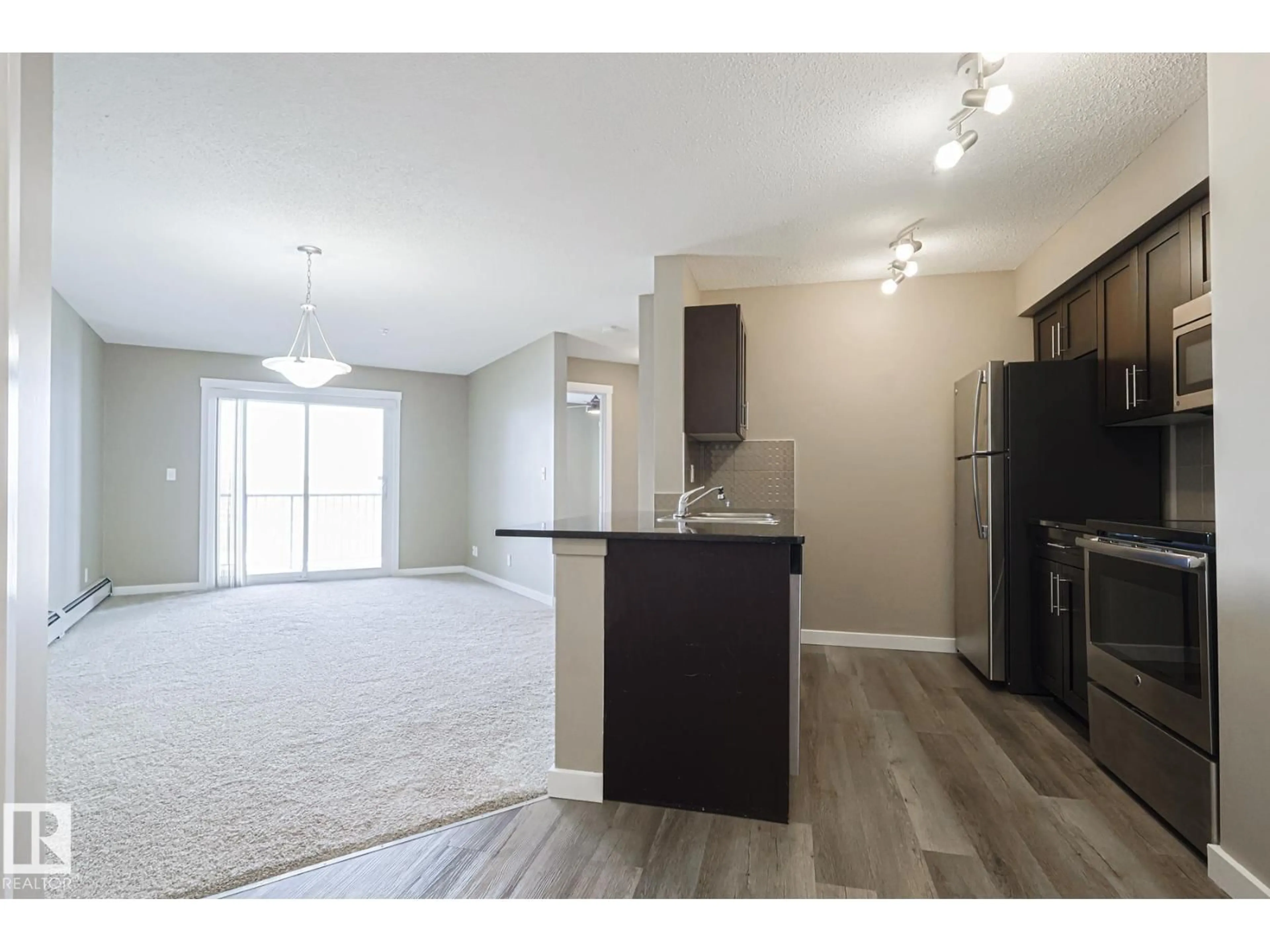Open concept kitchen, wood/laminate floor for #313 - 1510 WATT DR, Edmonton Alberta T6X2E6