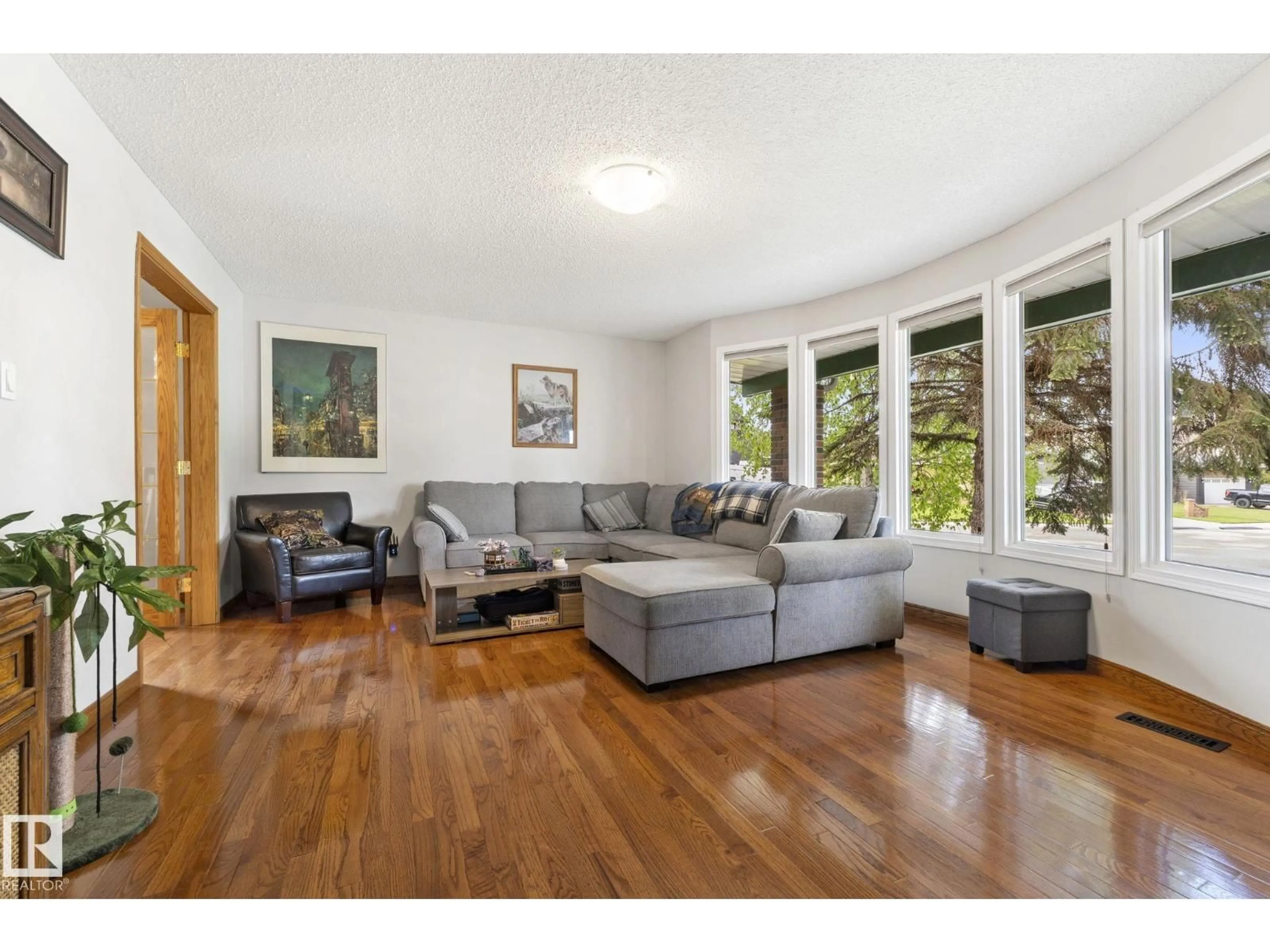 Living room with furniture, wood/laminate floor for 9940 83 ST, Fort Saskatchewan Alberta T8L3H3