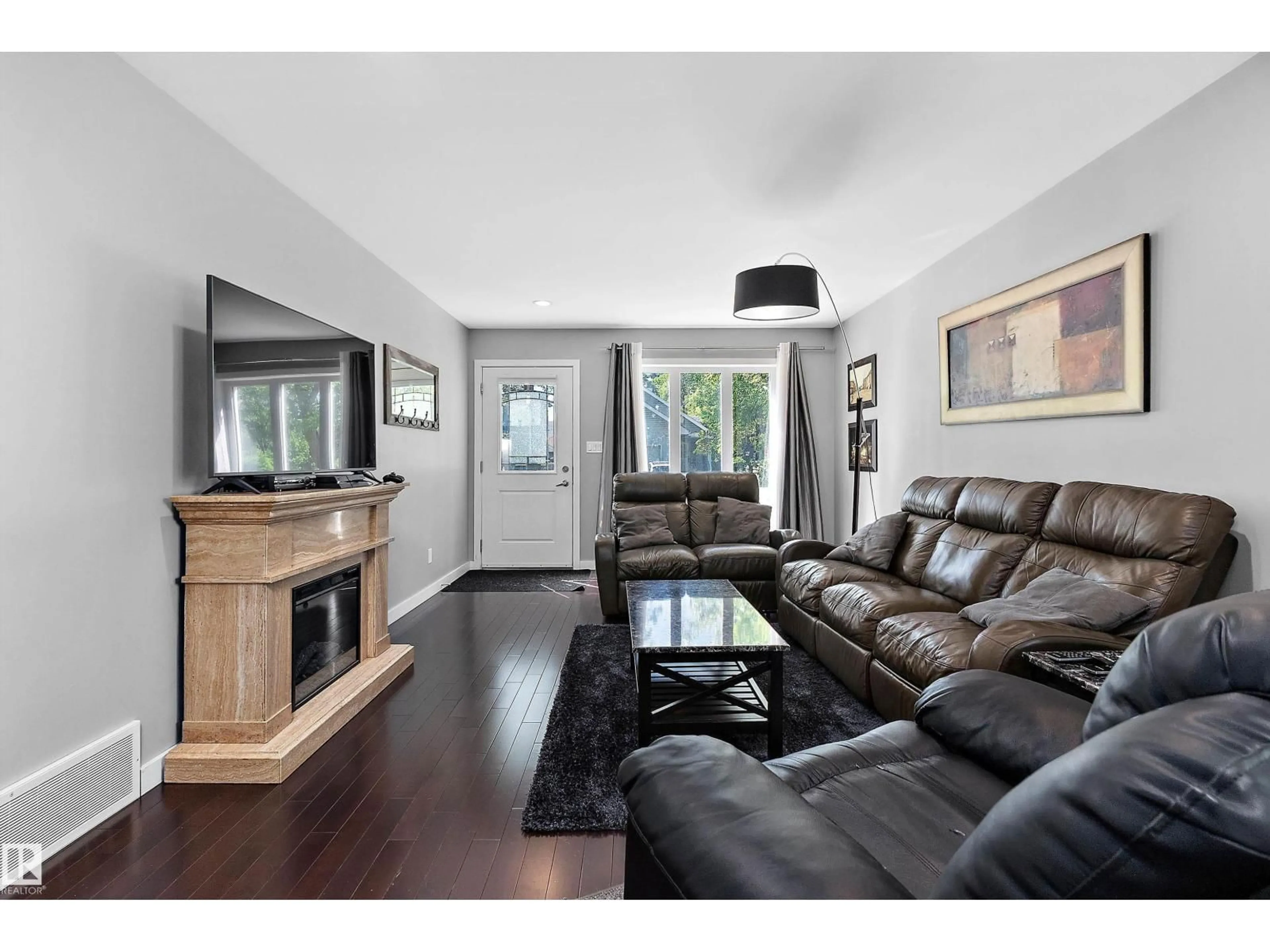 Living room with furniture, wood/laminate floor for 14832 103 AVE, Edmonton Alberta T5N0V1