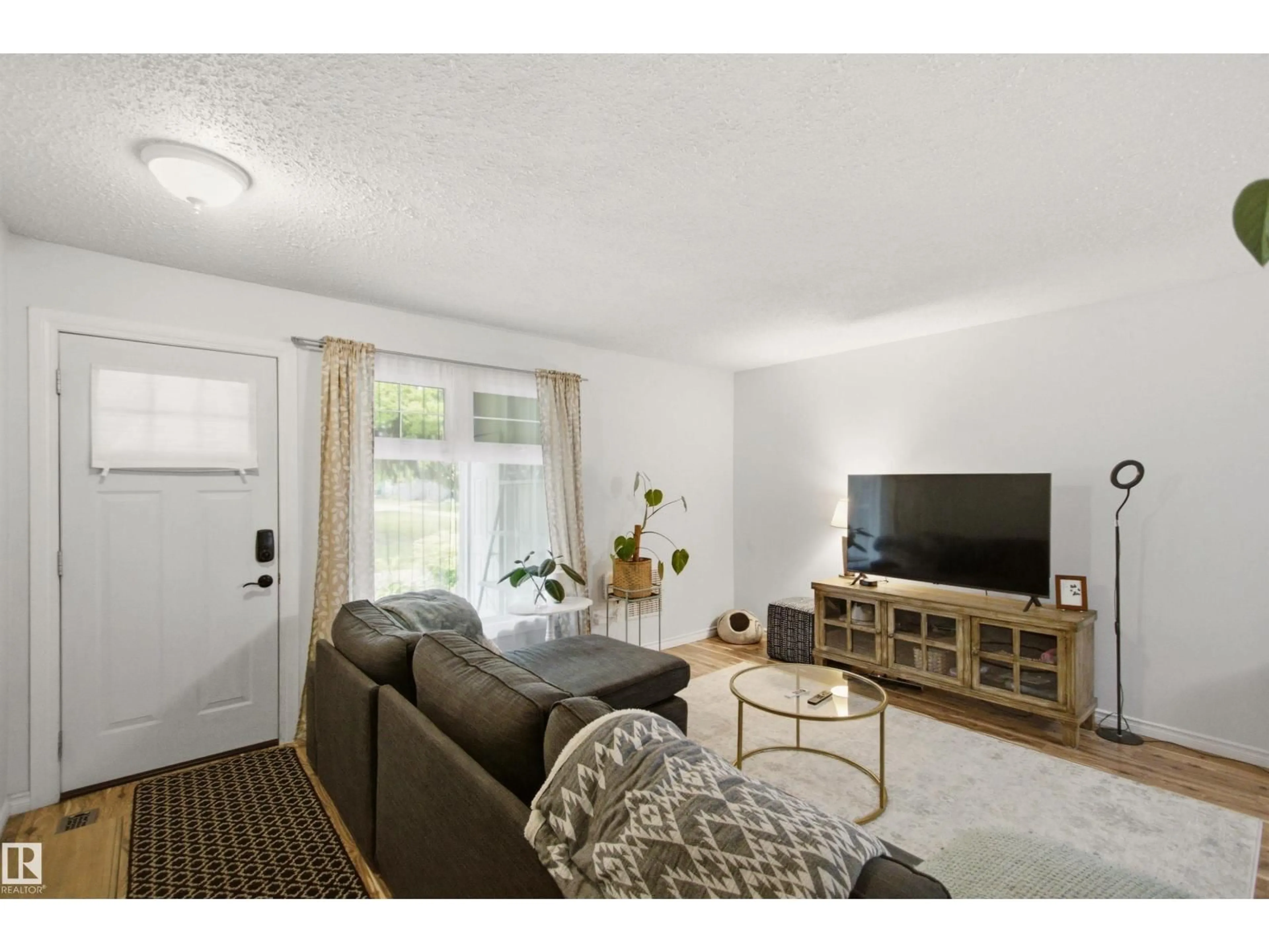 Living room with furniture, wood/laminate floor for NW - 5786 172 ST, Edmonton Alberta T6M1B4