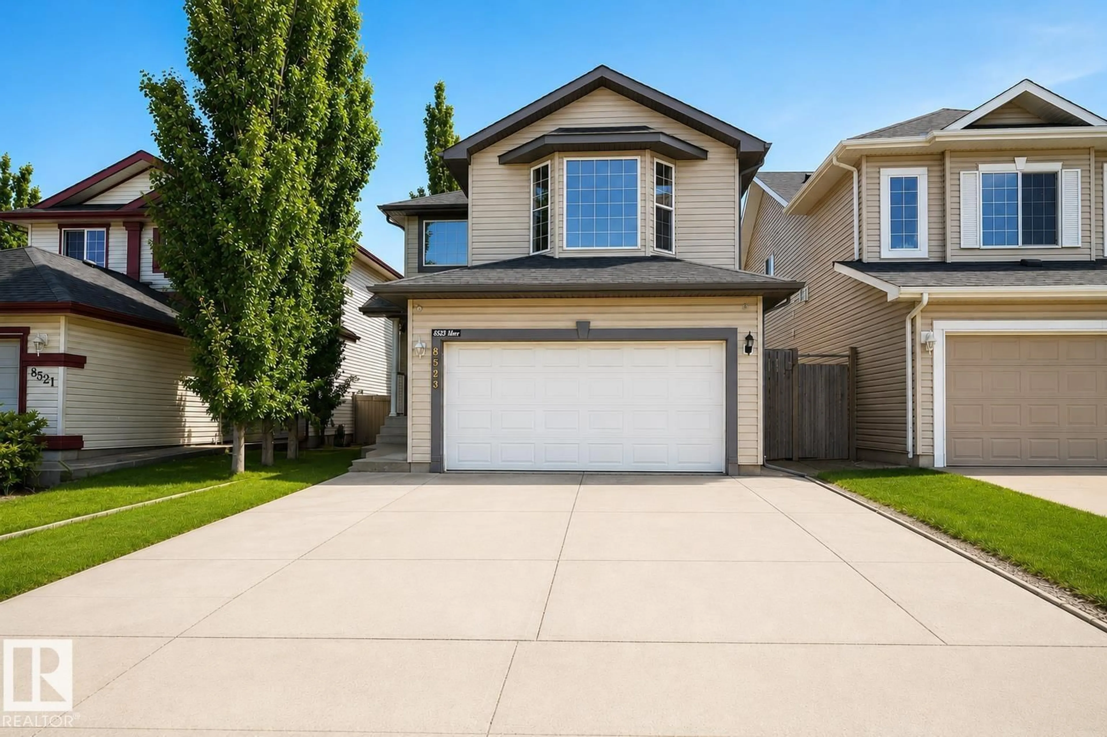 Home with vinyl exterior material, street for 8523 7 AV SW, Edmonton Alberta T6X1G3