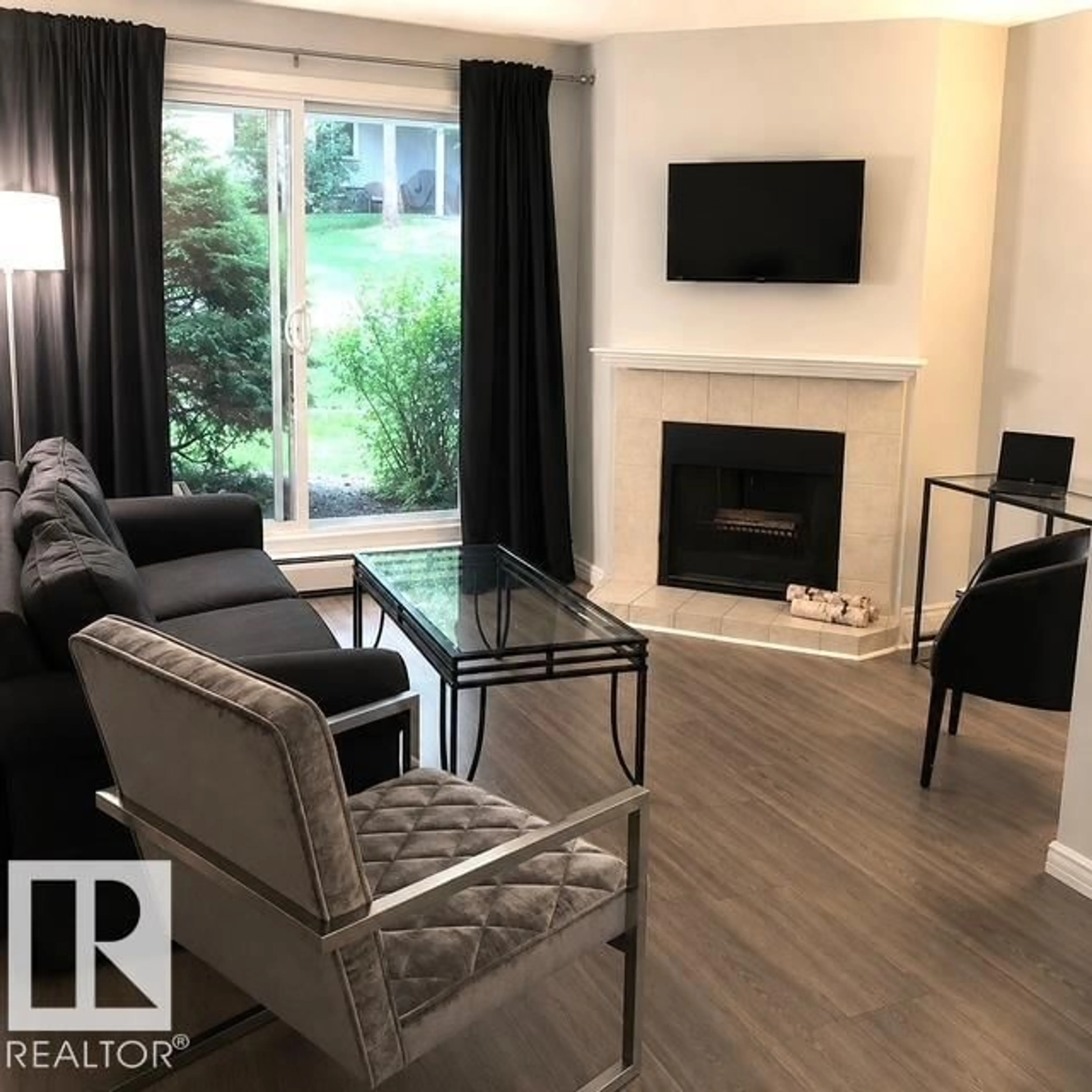 Living room with furniture, wood/laminate floor for #102 - 340 WOODBRIDGE WY, Sherwood Park Alberta T8A4G3