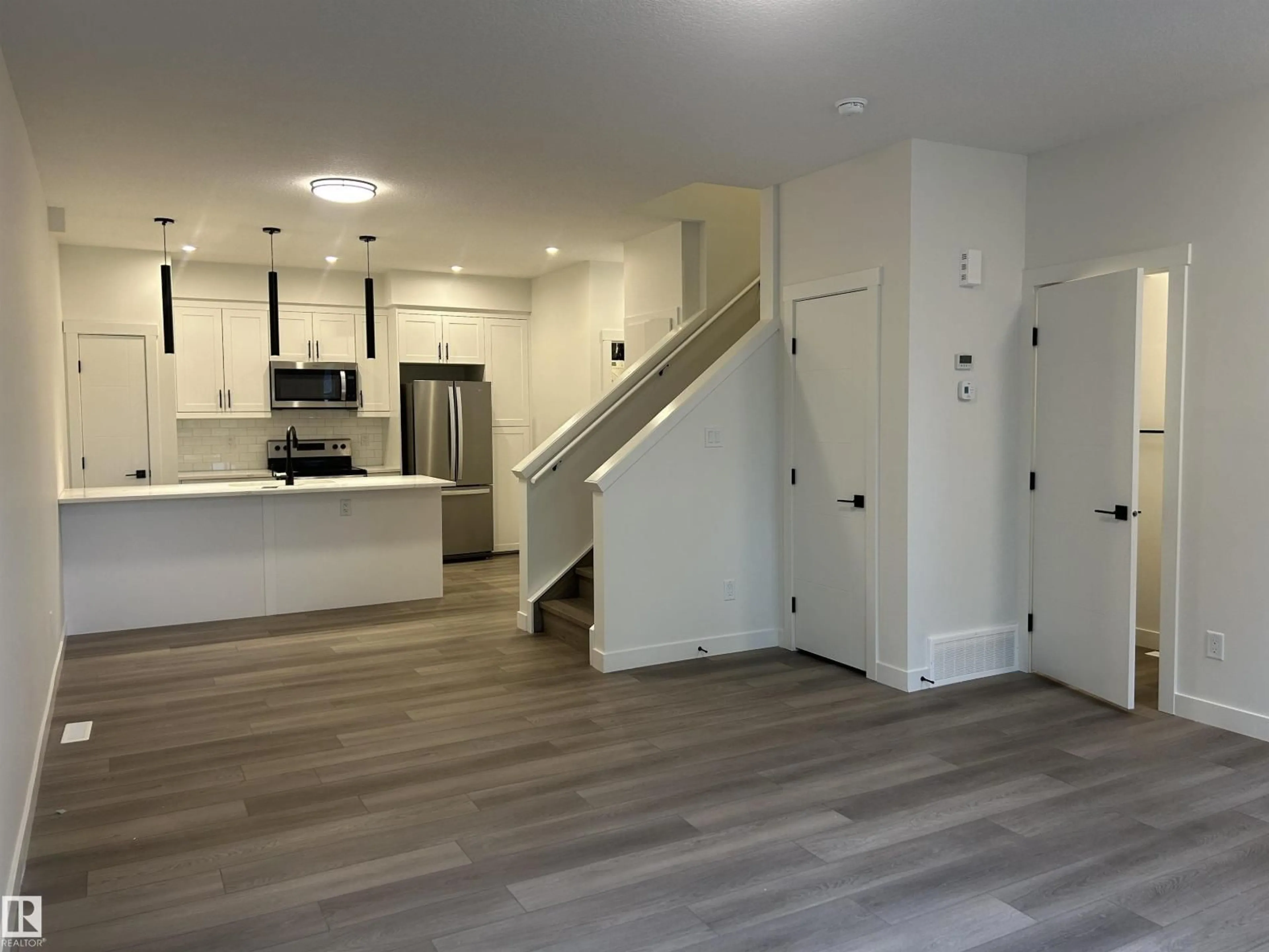 Open concept kitchen, wood/laminate floor for NW - 11007 132 ST, Edmonton Alberta T5M1E4