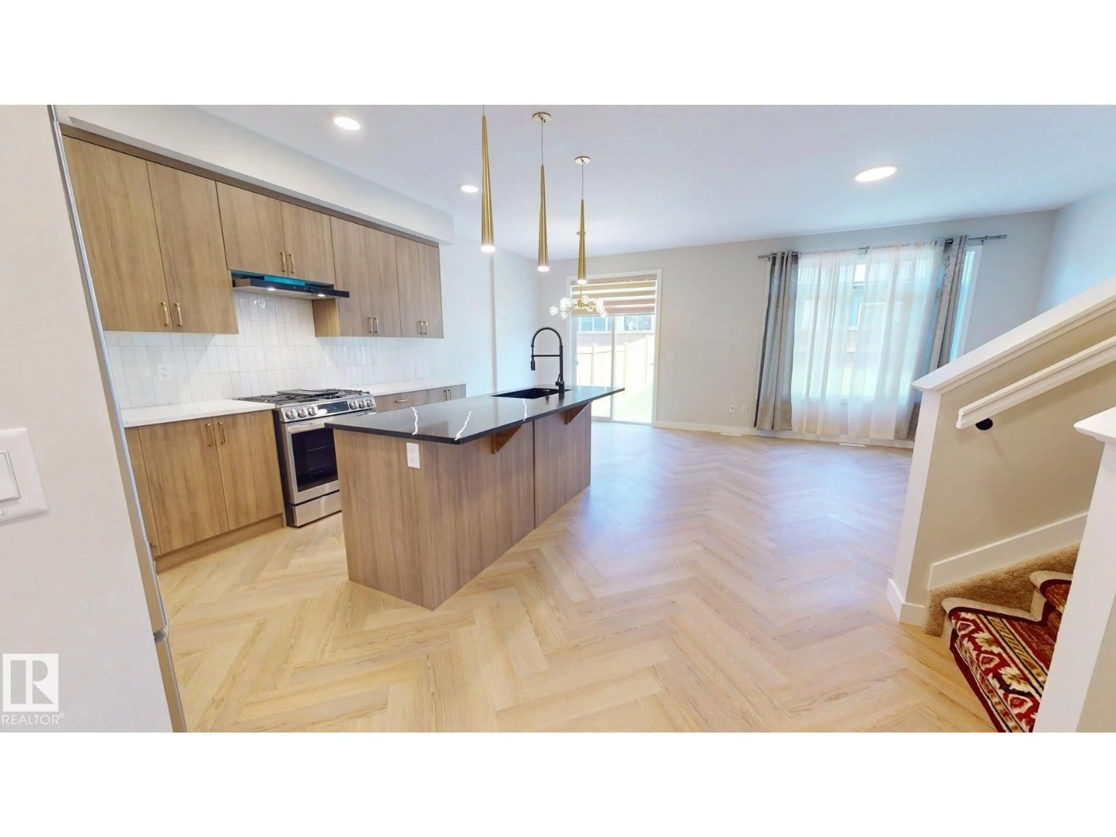 Open concept kitchen, wood/laminate floor for 6404 27 AV, Edmonton Alberta T6X3G4