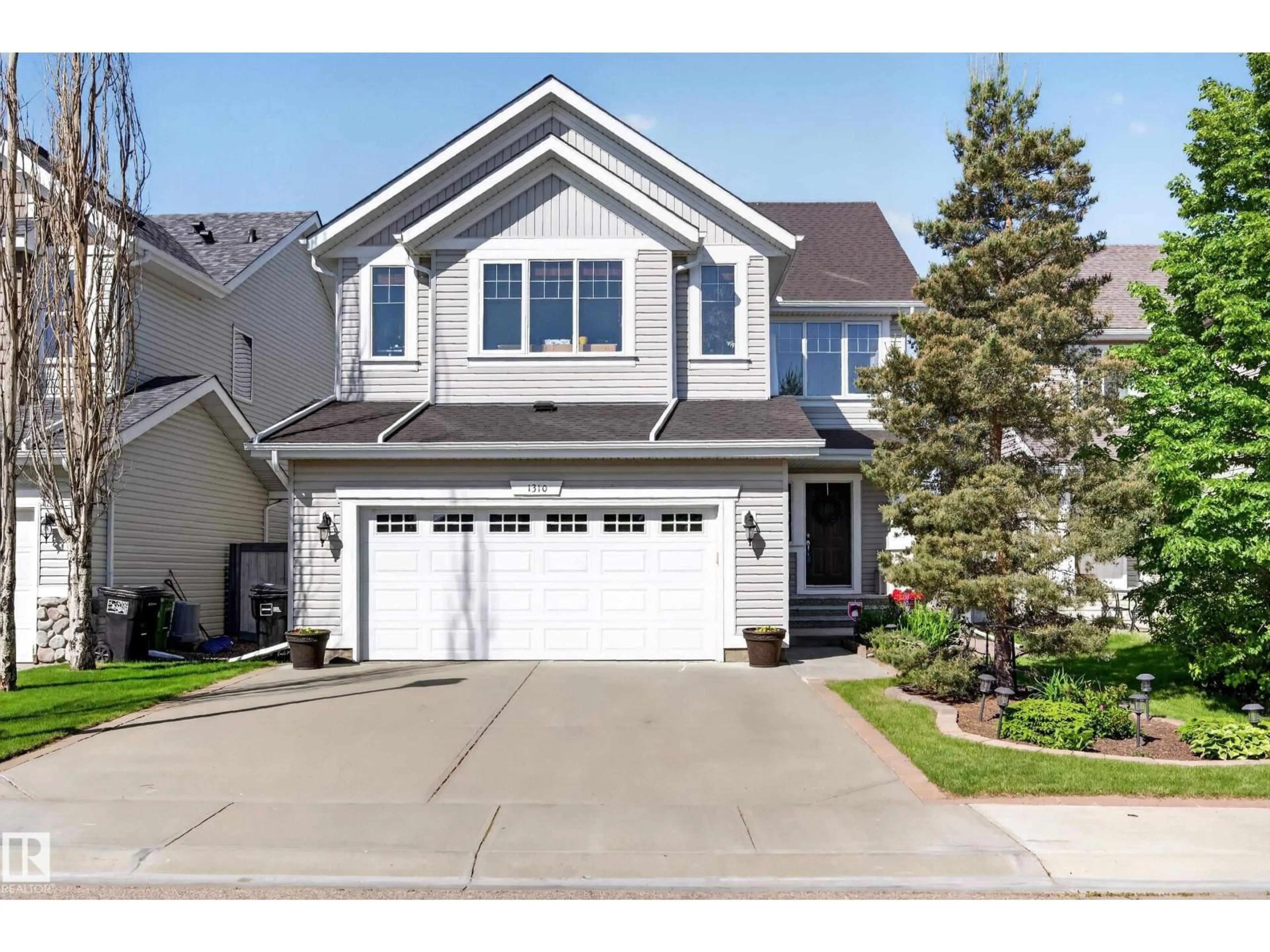 Home with vinyl exterior material, street for 1310 82 ST, Edmonton Alberta T6X0A6