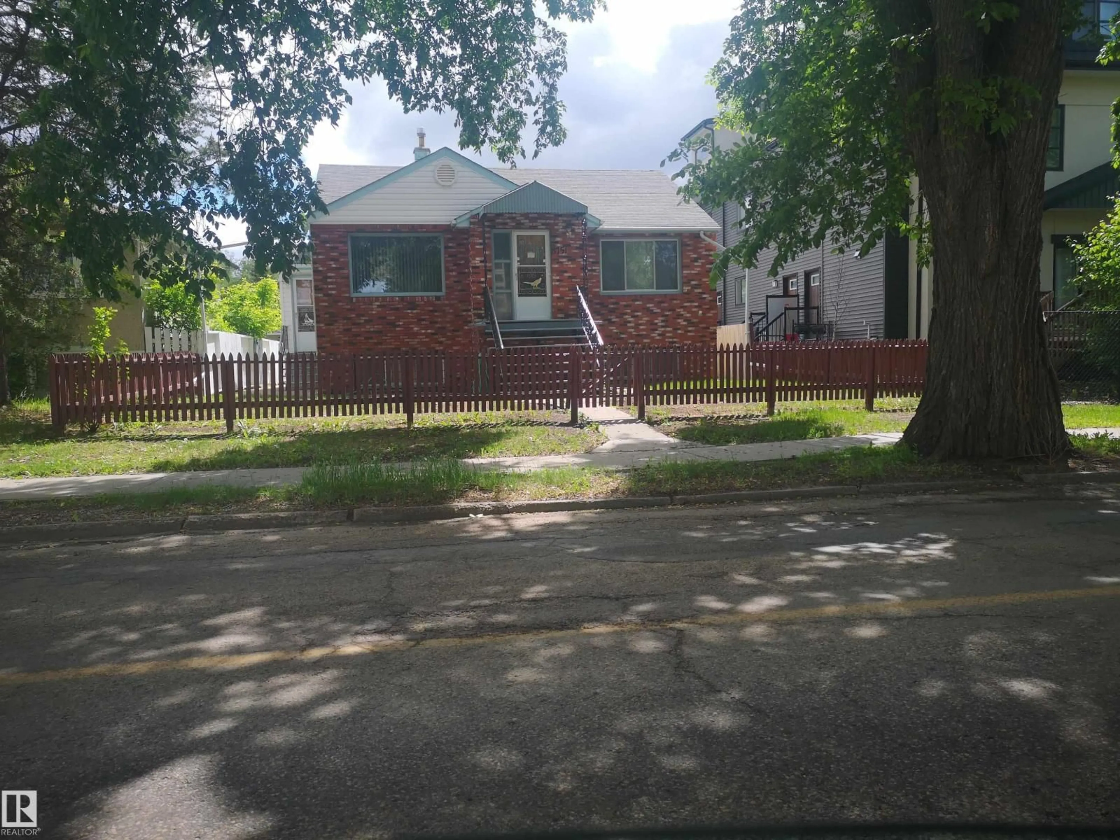 Home with brick exterior material, street for NW - 8751 76 AV, Edmonton Alberta T6C0J4
