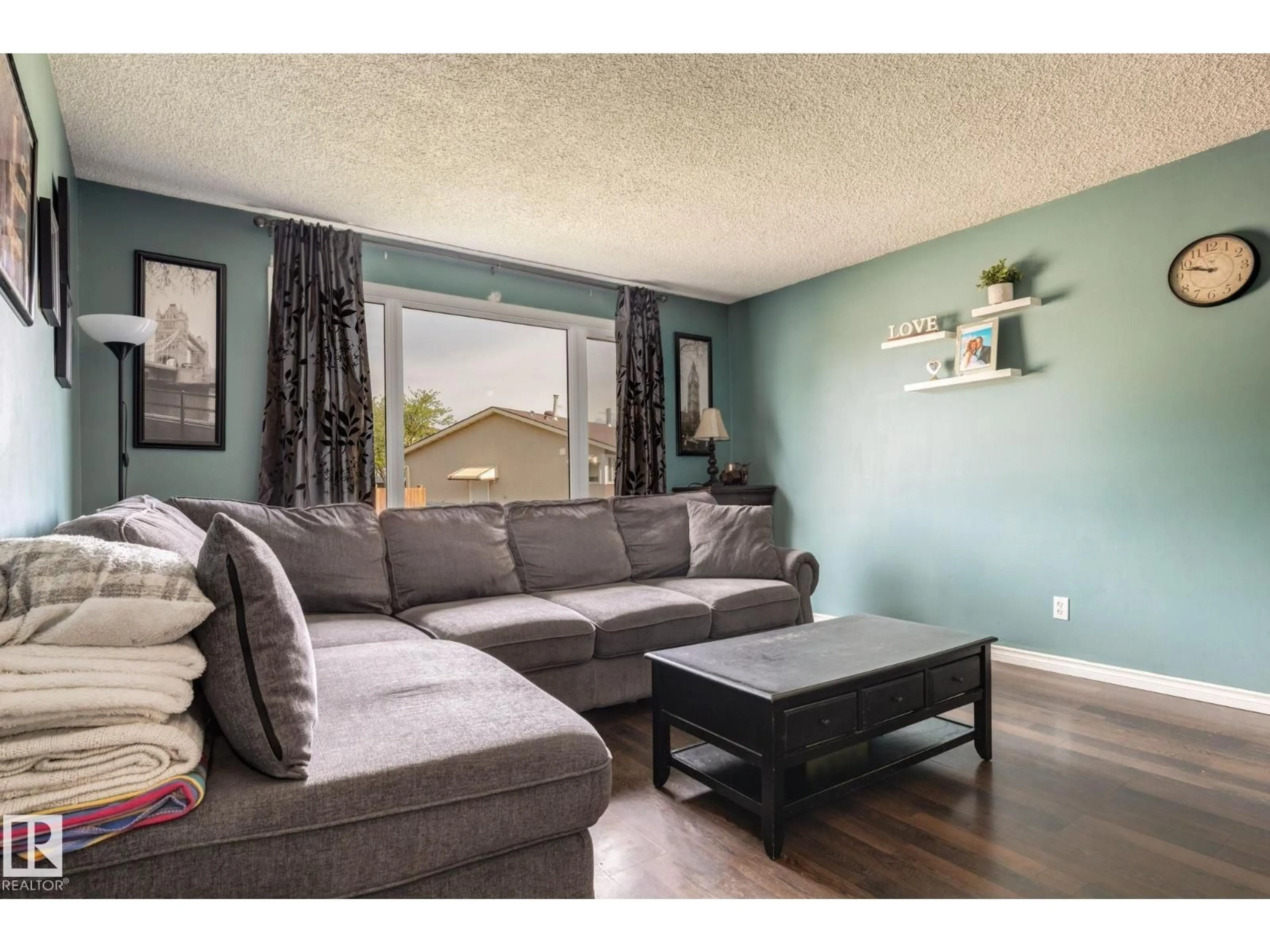 Living room with furniture, wood/laminate floor for NW - 13825 114 ST, Edmonton Alberta T5X4A1