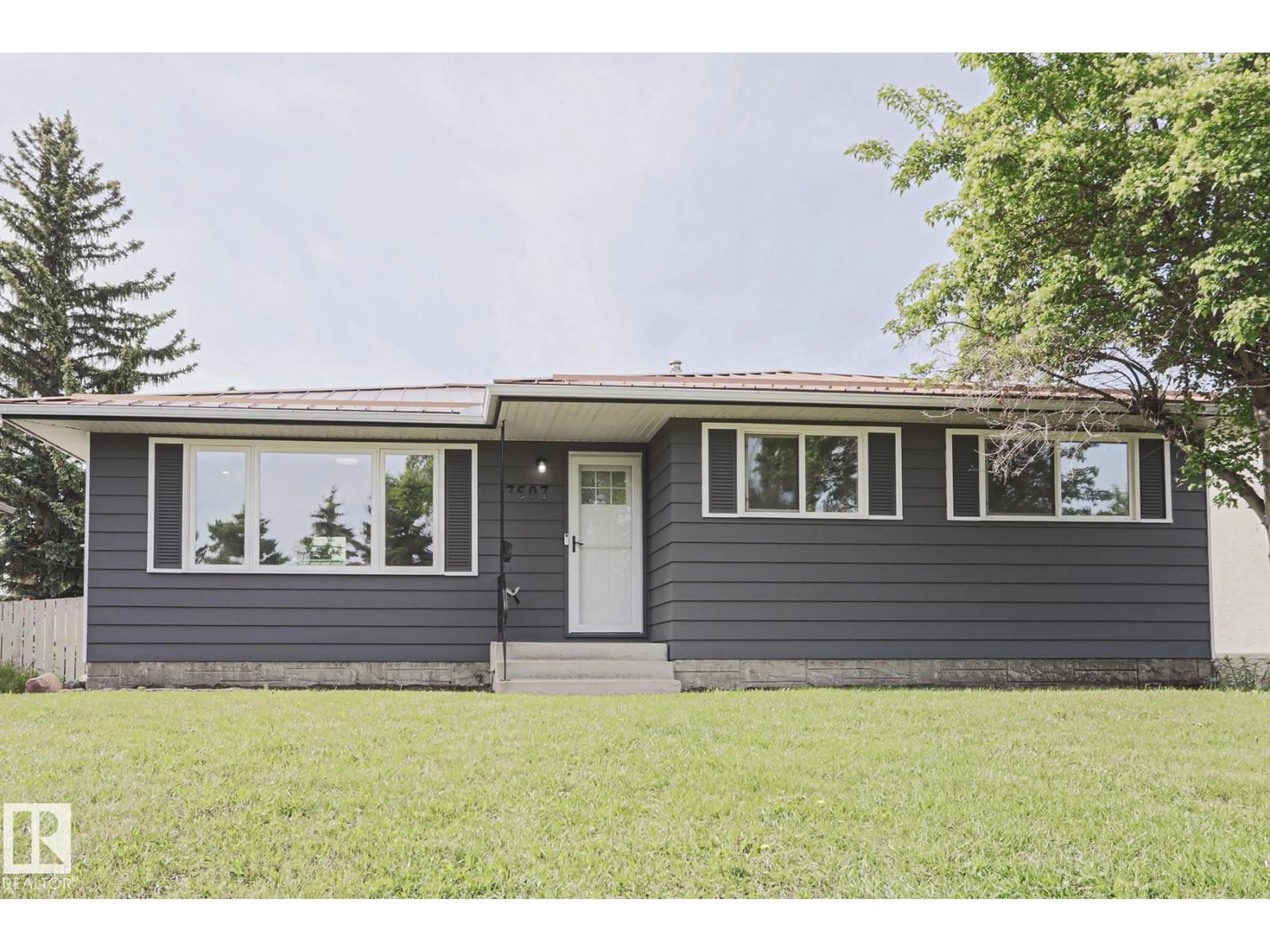 Home with vinyl exterior material, street for 7607 137 AV NW, Edmonton Alberta T5C2L6
