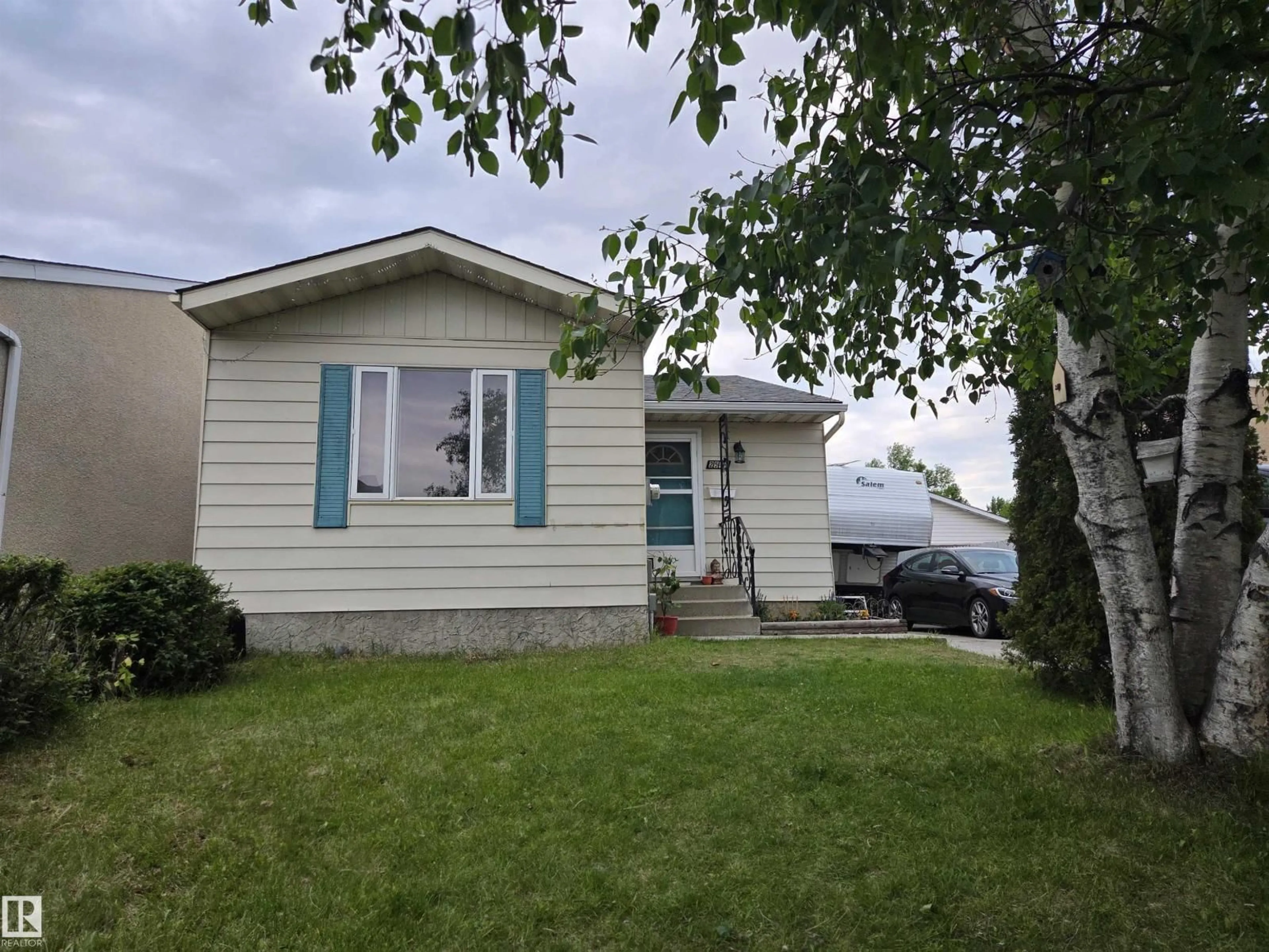 Home with vinyl exterior material, street for NW - 2514 149 AV, Edmonton Alberta T5Y1X3