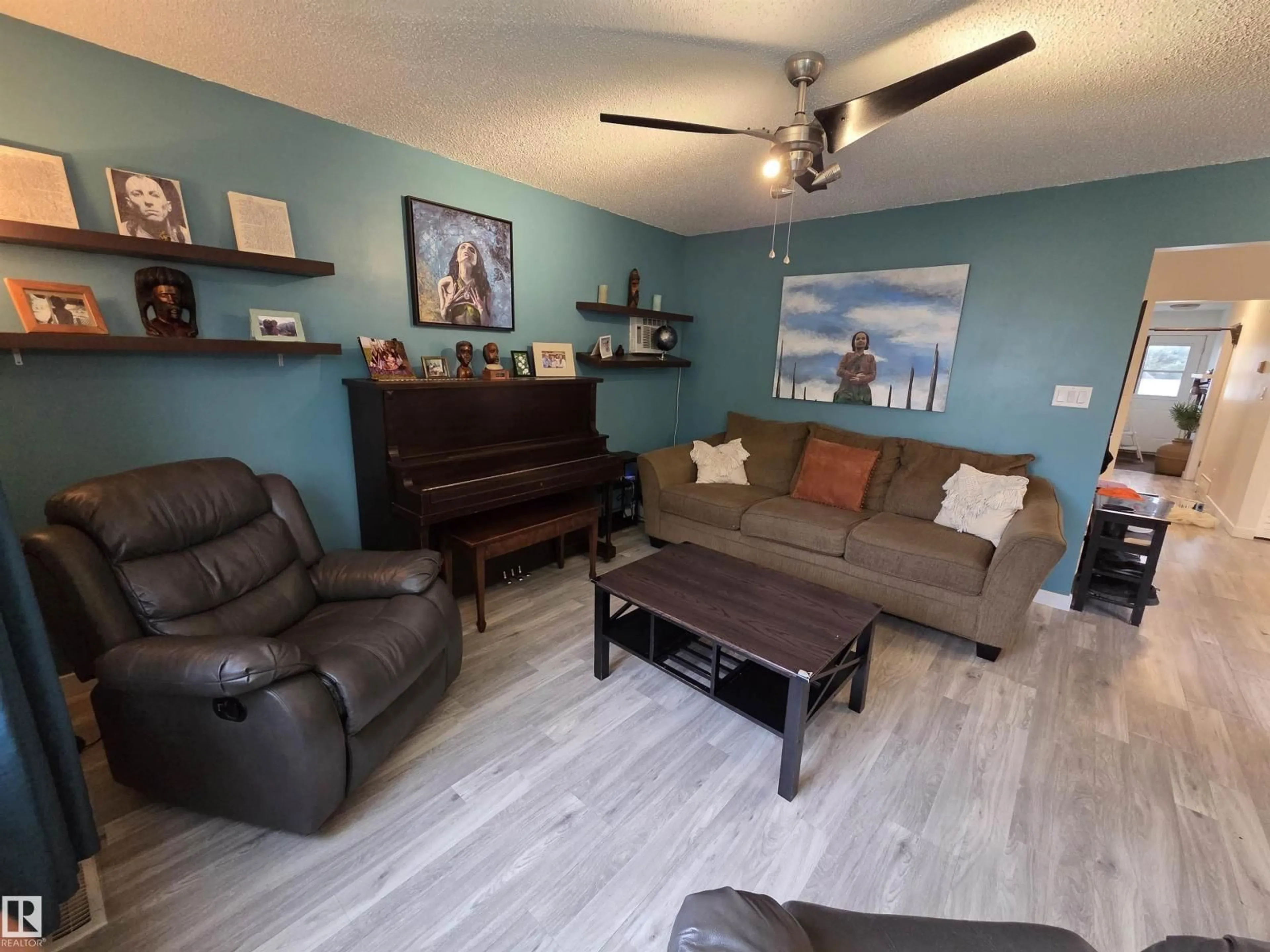 Living room with furniture, wood/laminate floor for NW - 2514 149 AV, Edmonton Alberta T5Y1X3