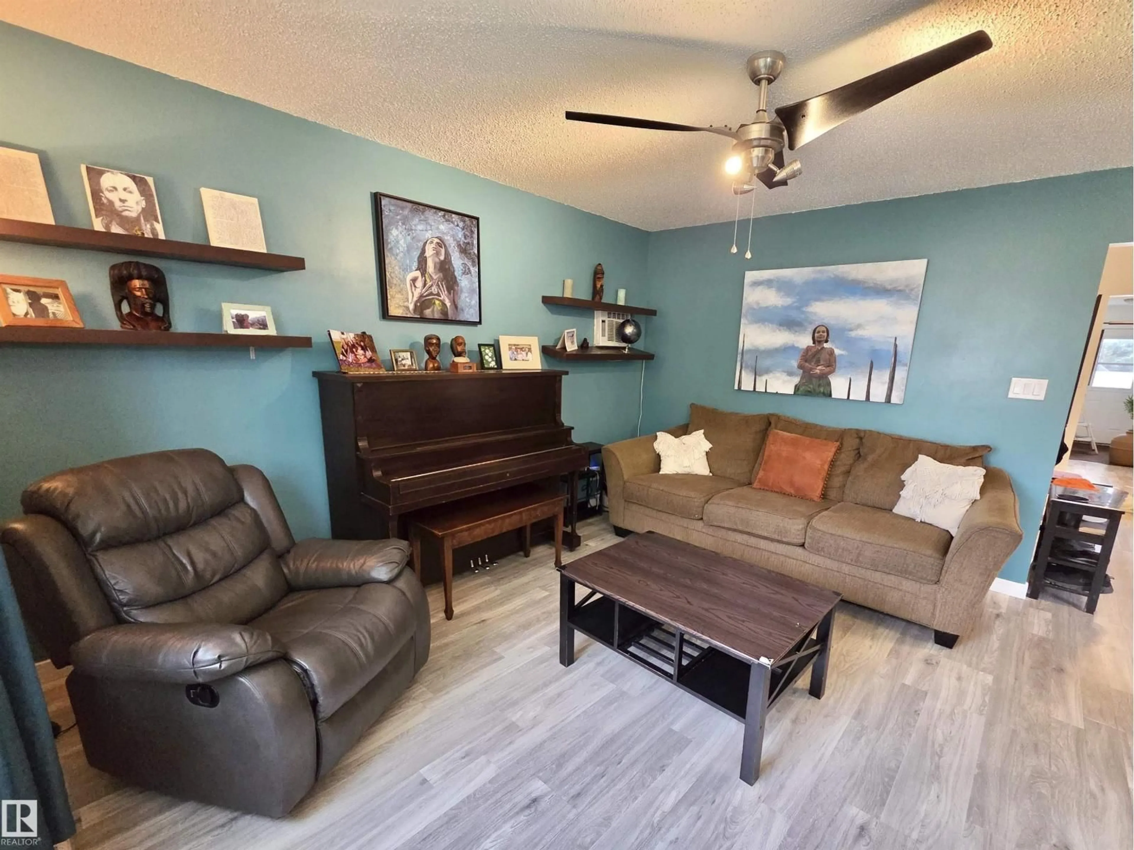 Living room with furniture, wood/laminate floor for NW - 2514 149 AV, Edmonton Alberta T5Y1X3