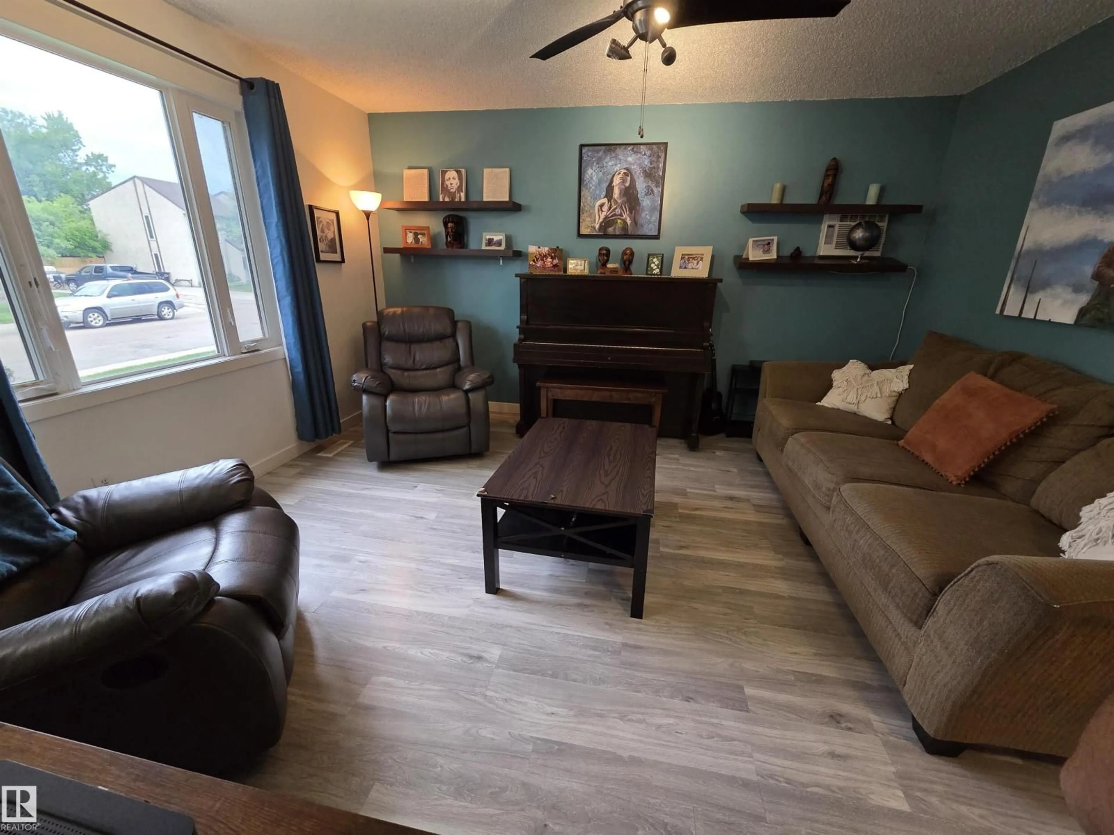 Living room with furniture, wood/laminate floor for NW - 2514 149 AV, Edmonton Alberta T5Y1X3