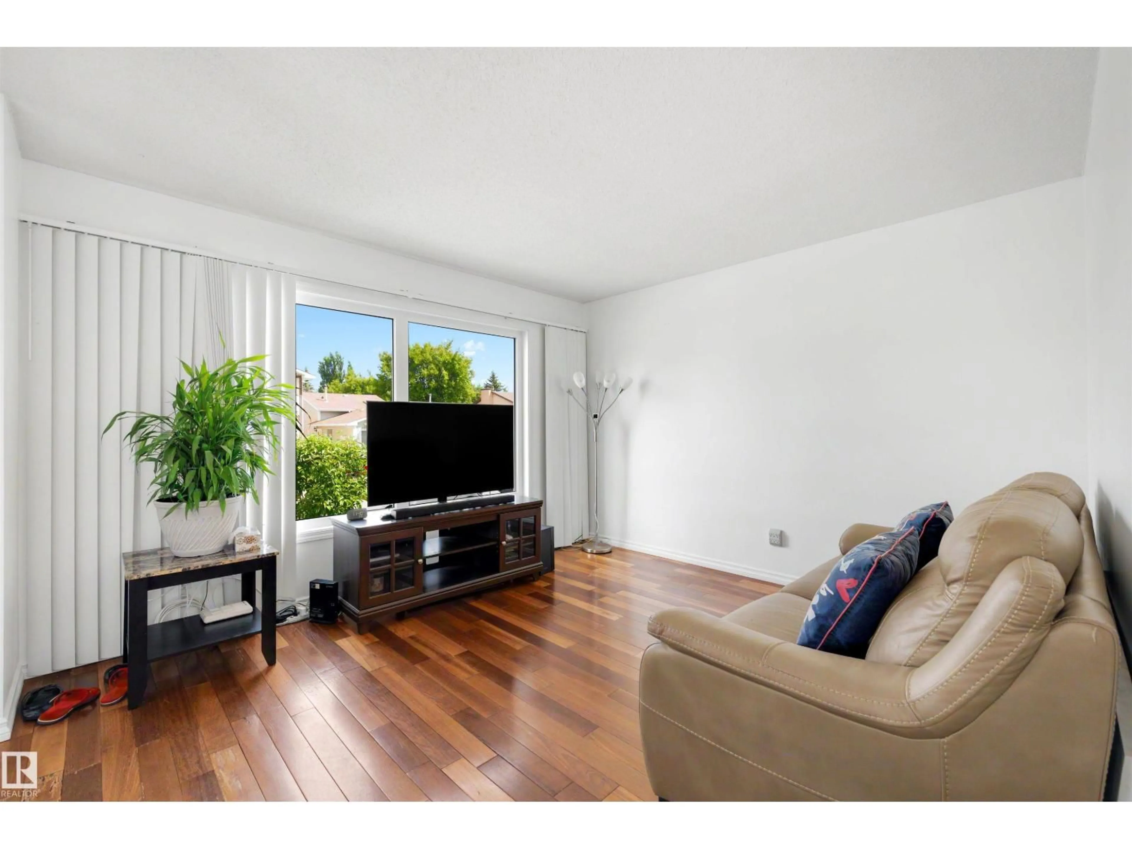 Living room with furniture, wood/laminate floor for NW - 18661 61 AV, Edmonton Alberta T6M2B3