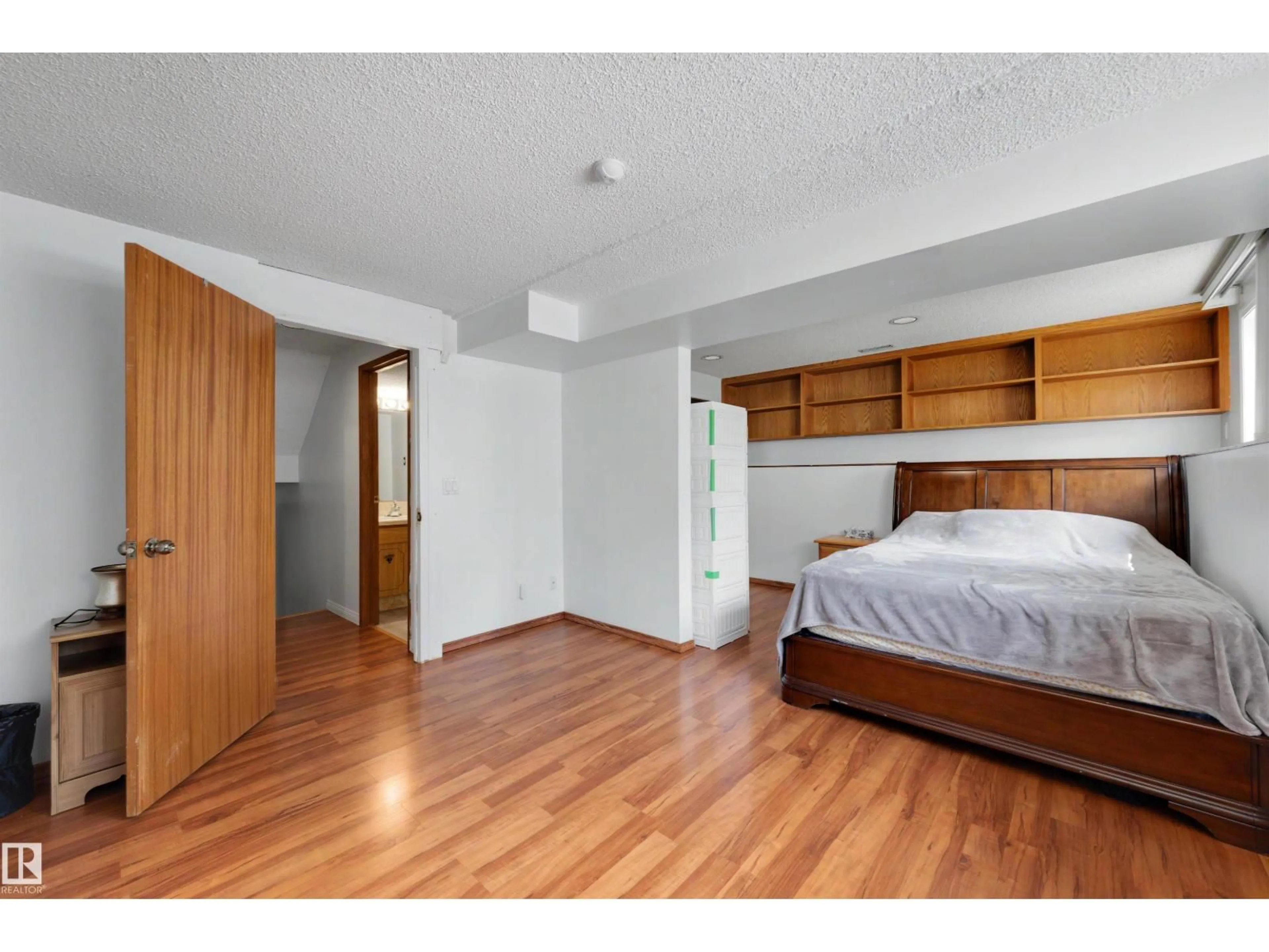 Bedroom with bed, wood/laminate floor for NW - 18661 61 AV, Edmonton Alberta T6M2B3
