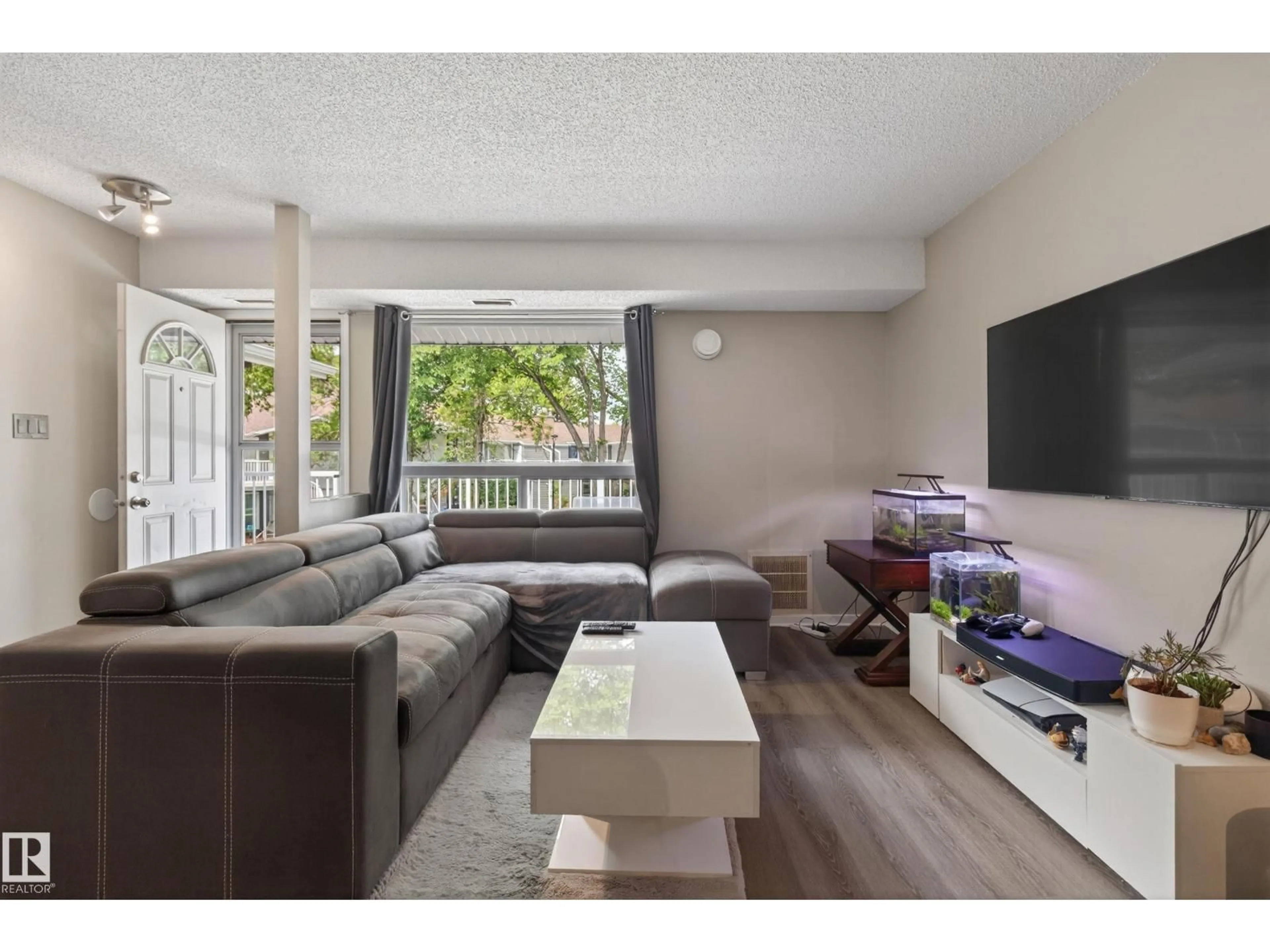 Living room with furniture, wood/laminate floor for 35 - 3111 142 AV NW, Edmonton Alberta T5Y2H6