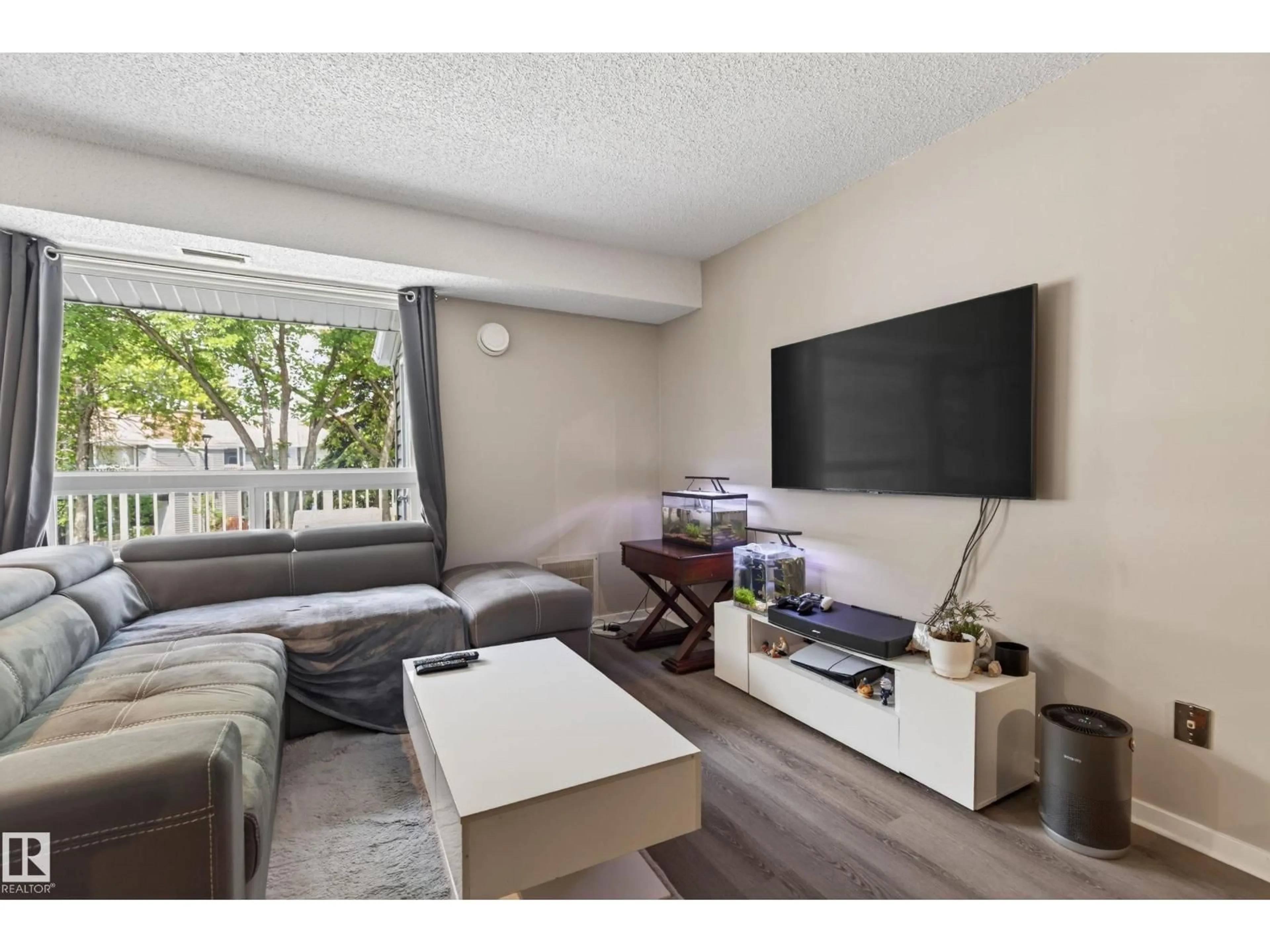 Living room with furniture, wood/laminate floor for 35 - 3111 142 AV NW, Edmonton Alberta T5Y2H6