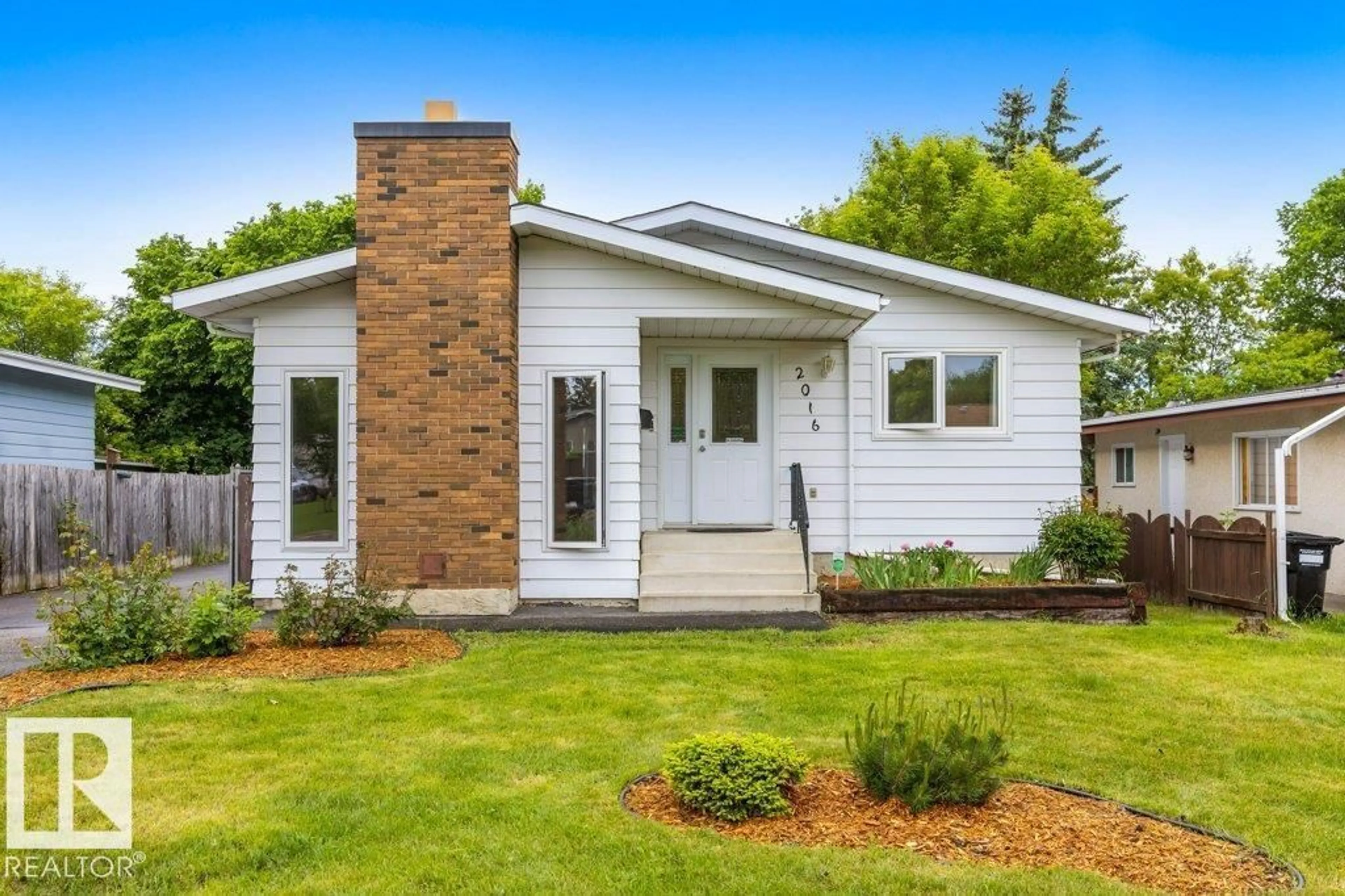 Home with vinyl exterior material, street for 2016 82 ST, Edmonton Alberta T6K1Z4