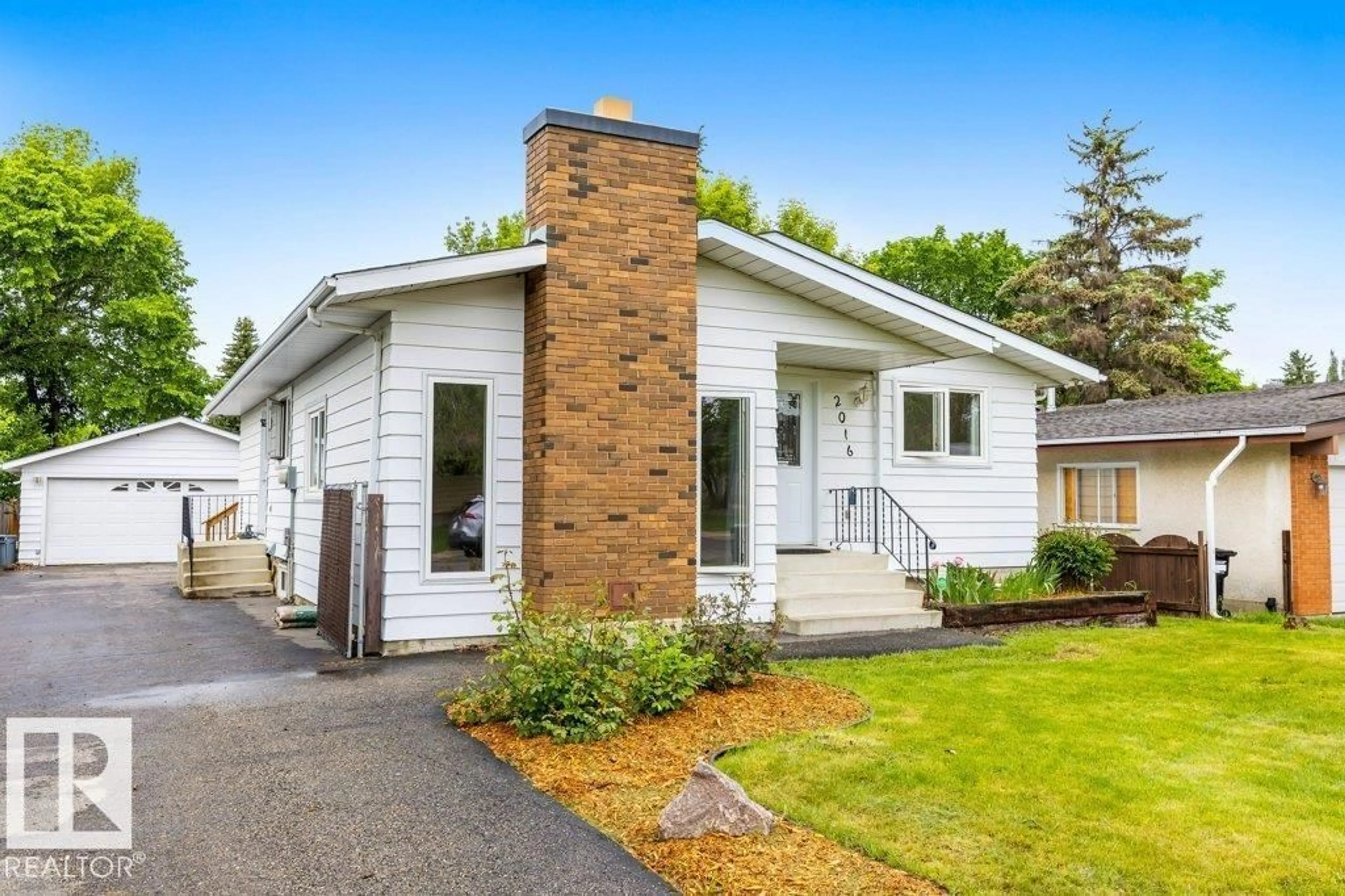 Home with vinyl exterior material, street for 2016 82 ST, Edmonton Alberta T6K1Z4