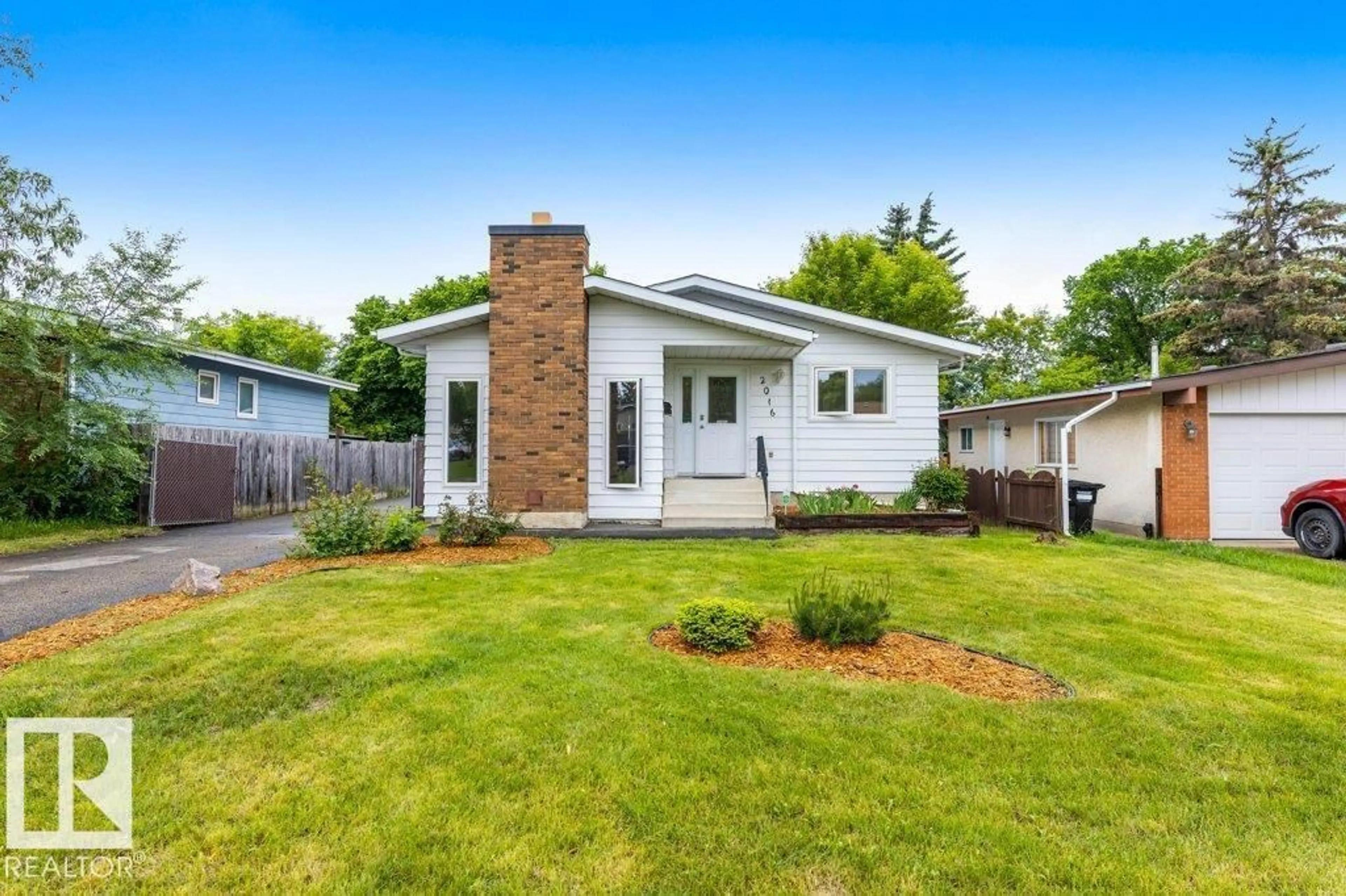 Home with vinyl exterior material, street for 2016 82 ST, Edmonton Alberta T6K1Z4