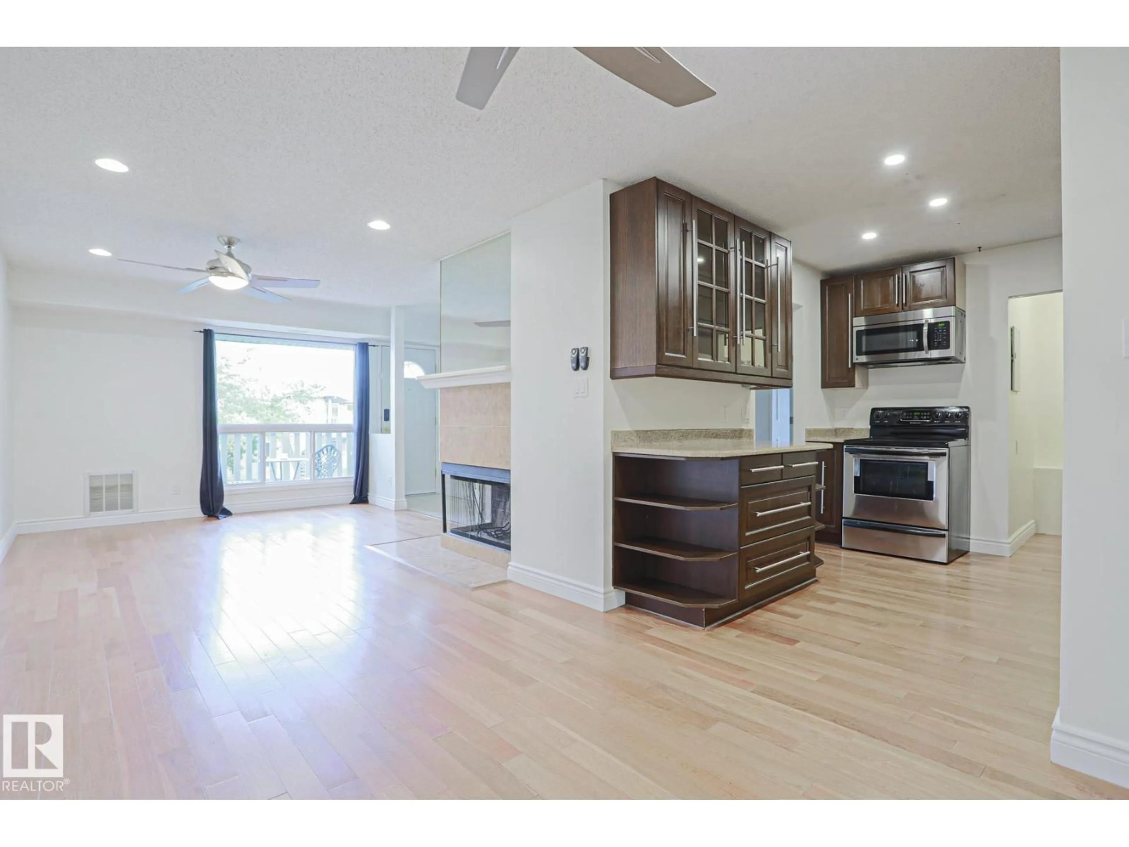 Open concept kitchen, wood/laminate floor for 52 - 2703 79 ST, Edmonton Alberta T6K3Z6
