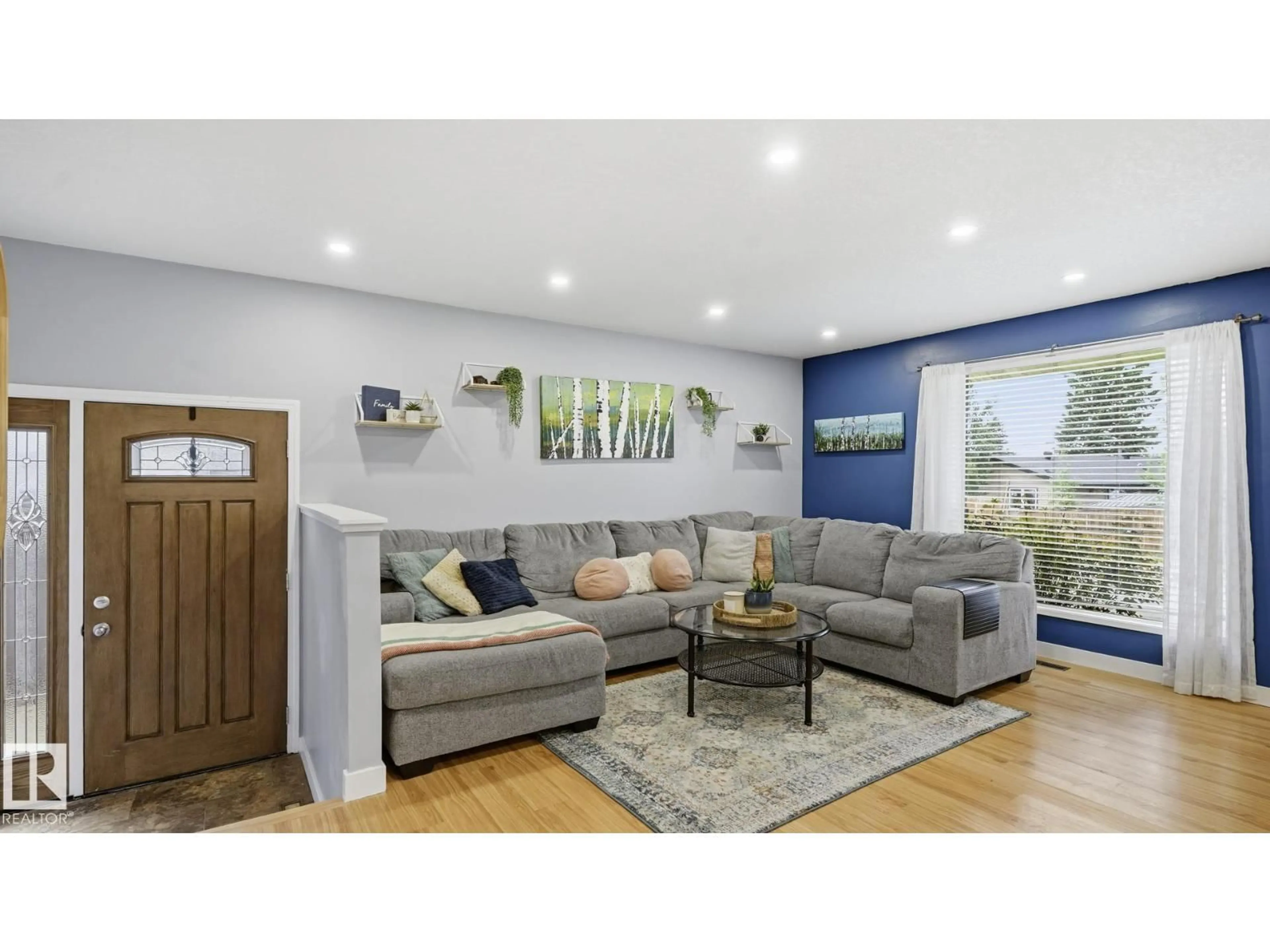 Living room with furniture, wood/laminate floor for 5507 51 AV, Beaumont Alberta T4X1E2