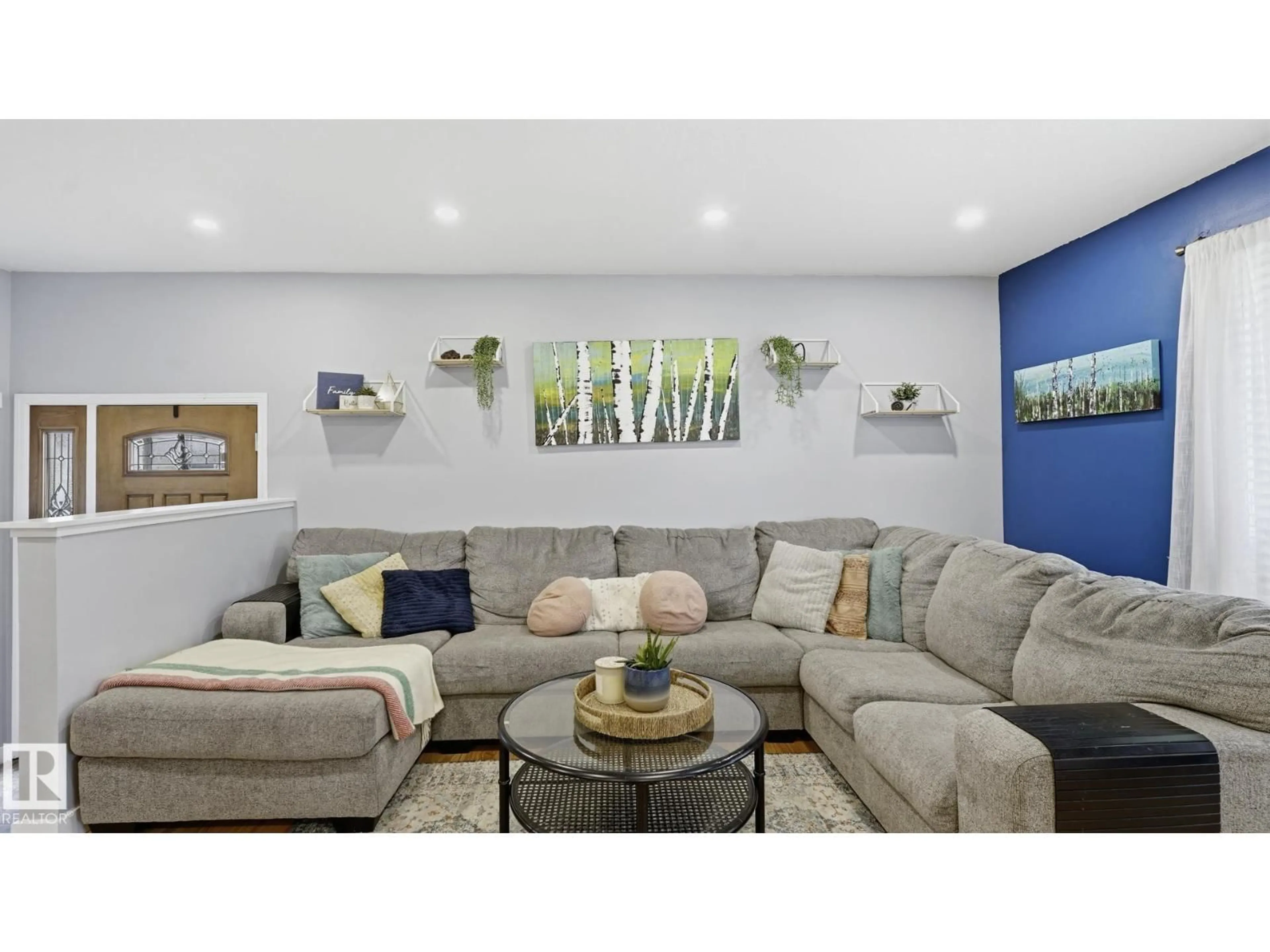 Living room with furniture, wood/laminate floor for 5507 51 AV, Beaumont Alberta T4X1E2