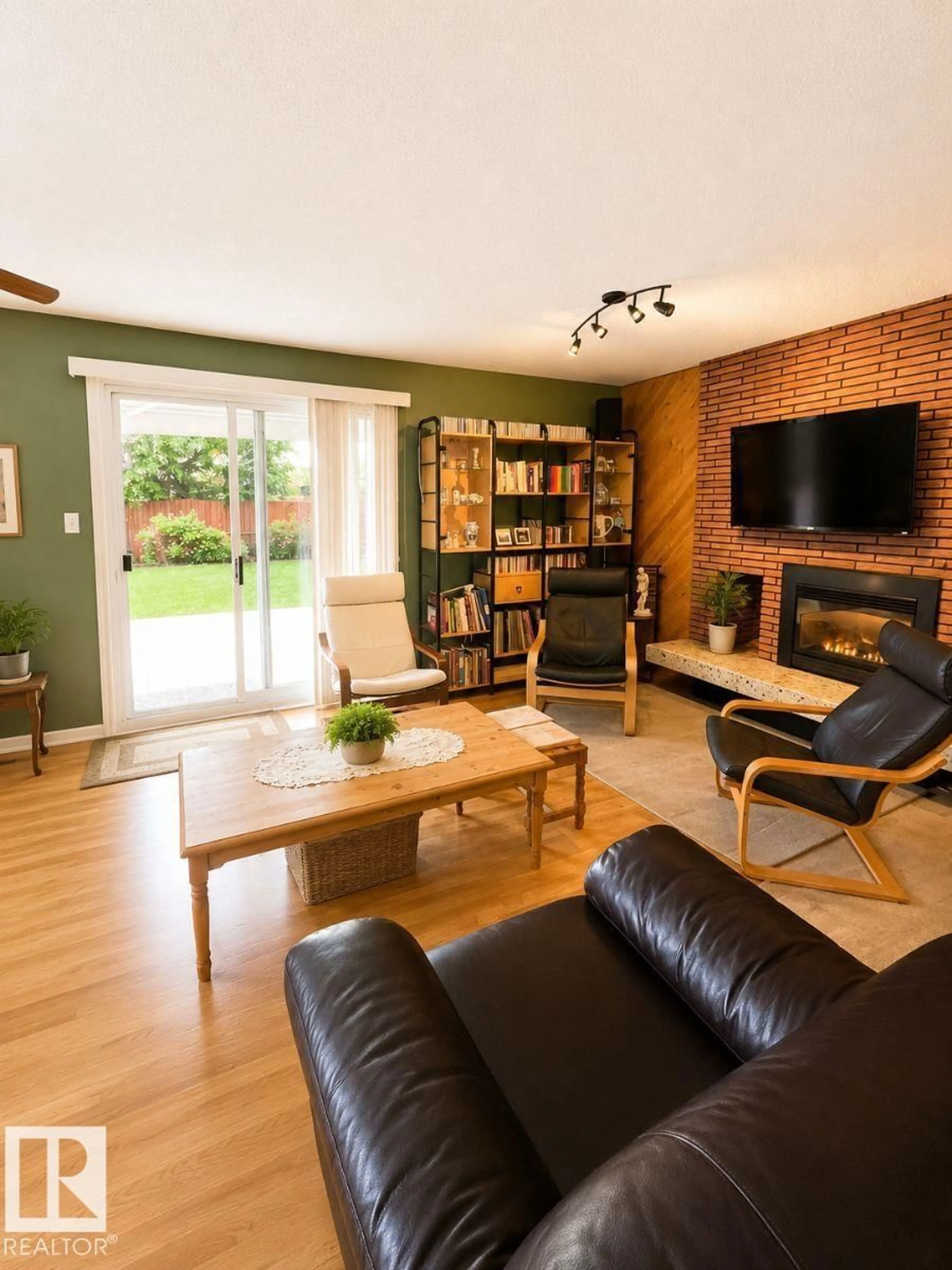 Living room with furniture, wood/laminate floor for 11015 144 ST, Edmonton Alberta T5N2W4