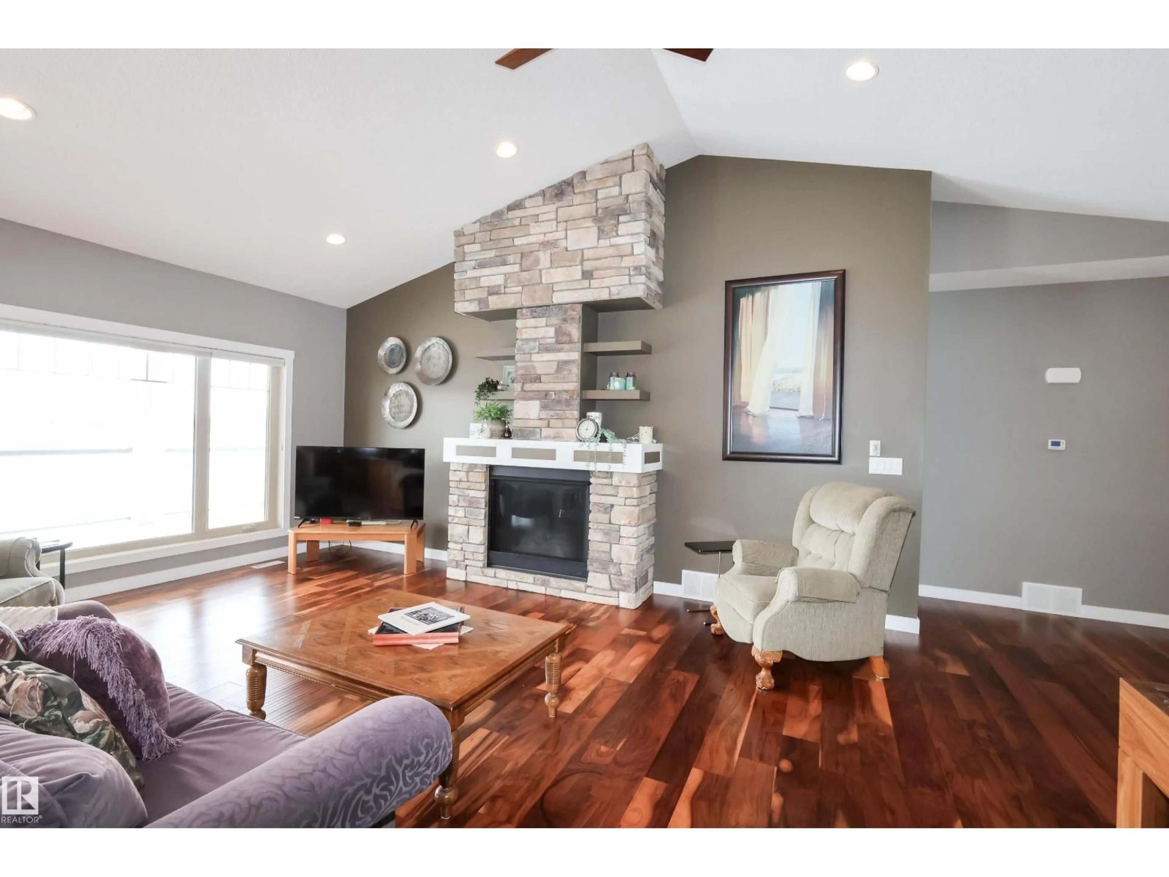 Living room with furniture, wood/laminate floor for 10508 103, Morinville Alberta T8R0E7