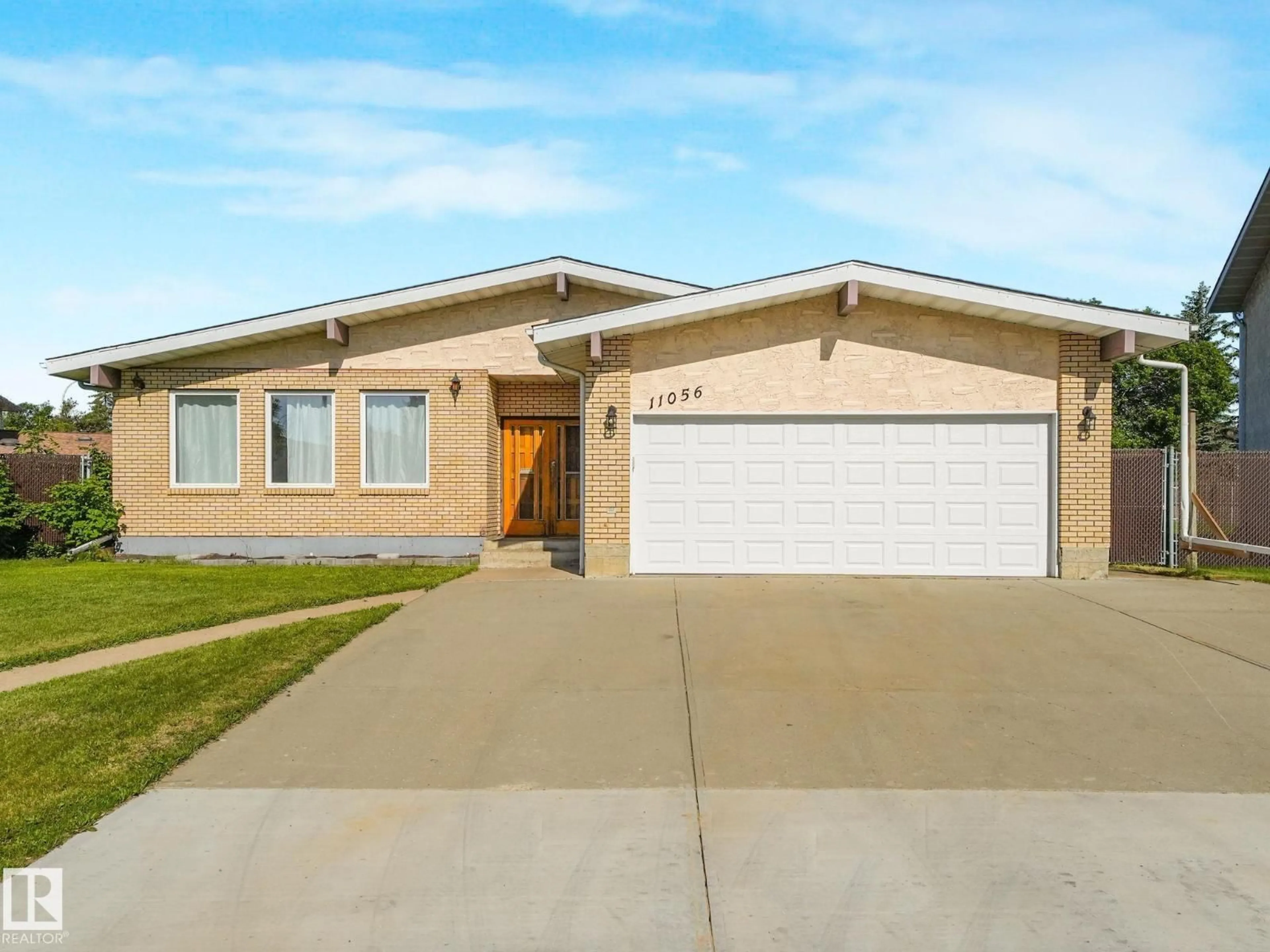 Home with brick exterior material, street for NW - 11056 166 AV, Edmonton Alberta T5X1Y3