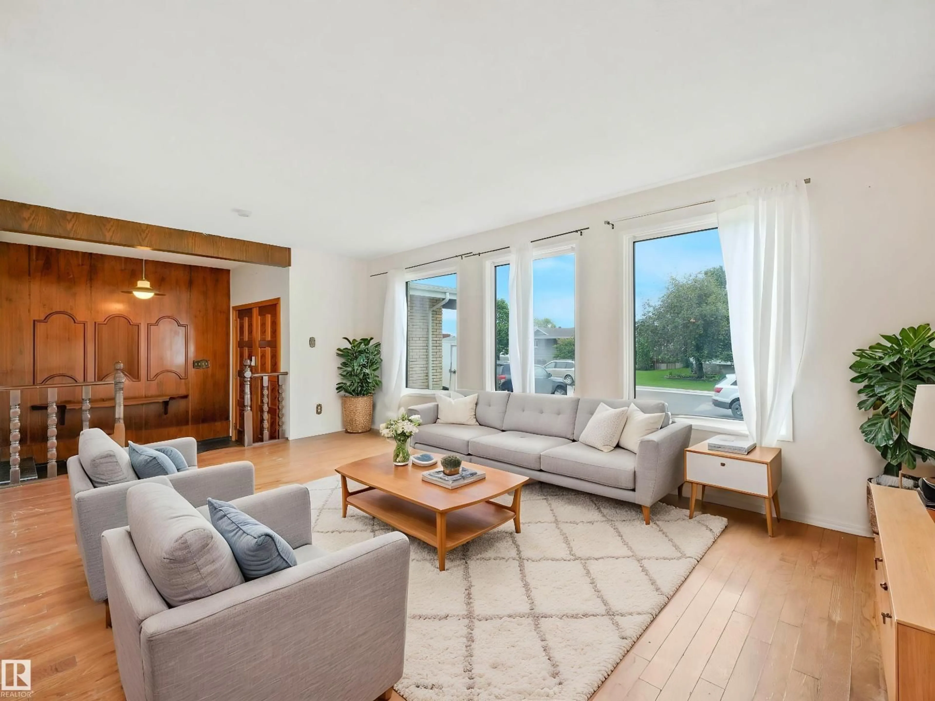 Living room with furniture, wood/laminate floor for NW - 11056 166 AV, Edmonton Alberta T5X1Y3
