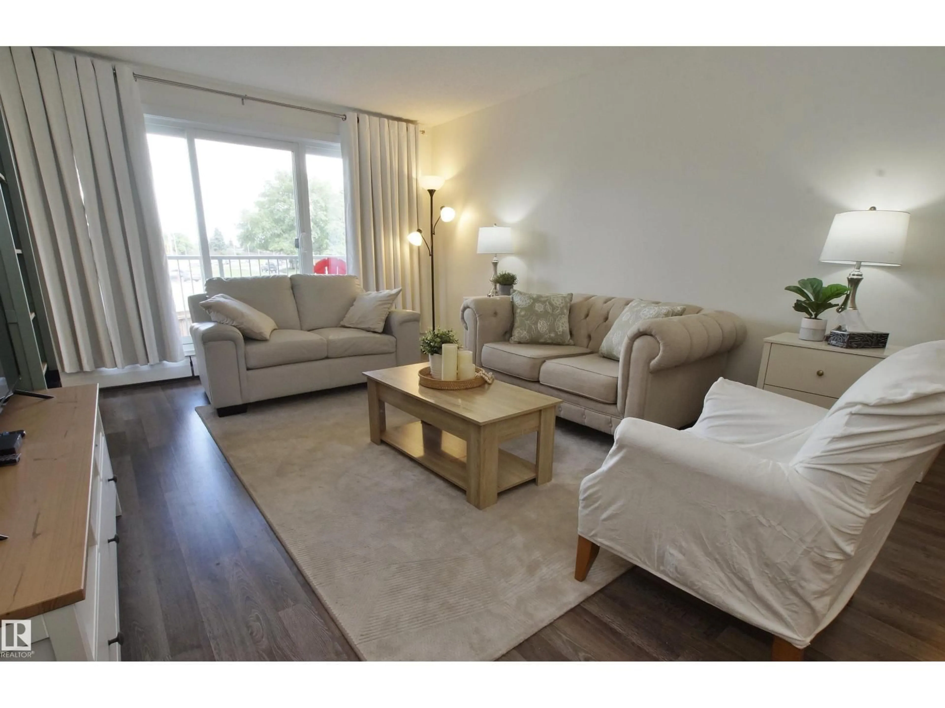 Living room with furniture, wood/laminate floor for 235 - 4404 122 ST, Edmonton Alberta T6H4E2