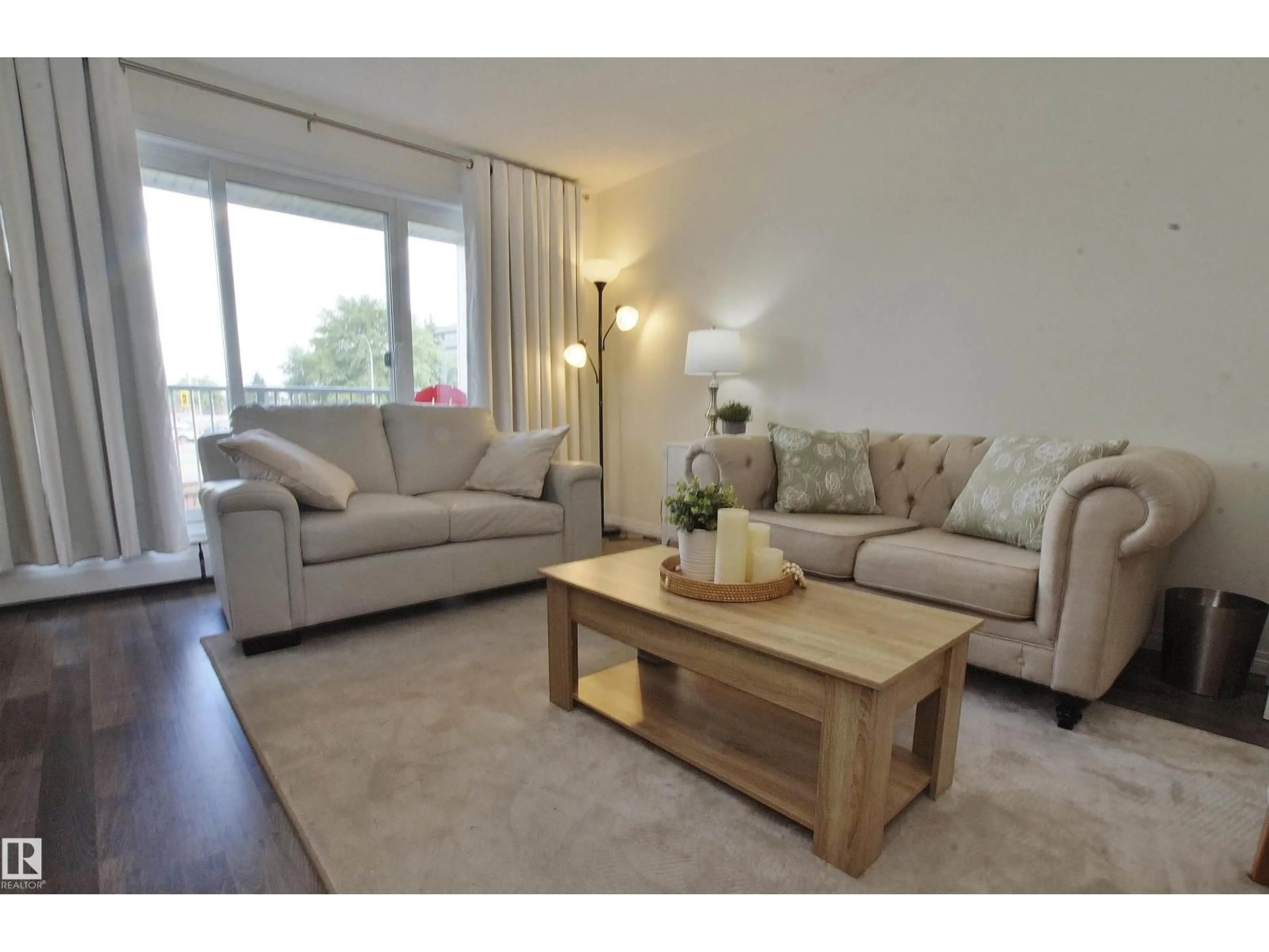 Living room with furniture, wood/laminate floor for 235 - 4404 122 ST, Edmonton Alberta T6H4E2