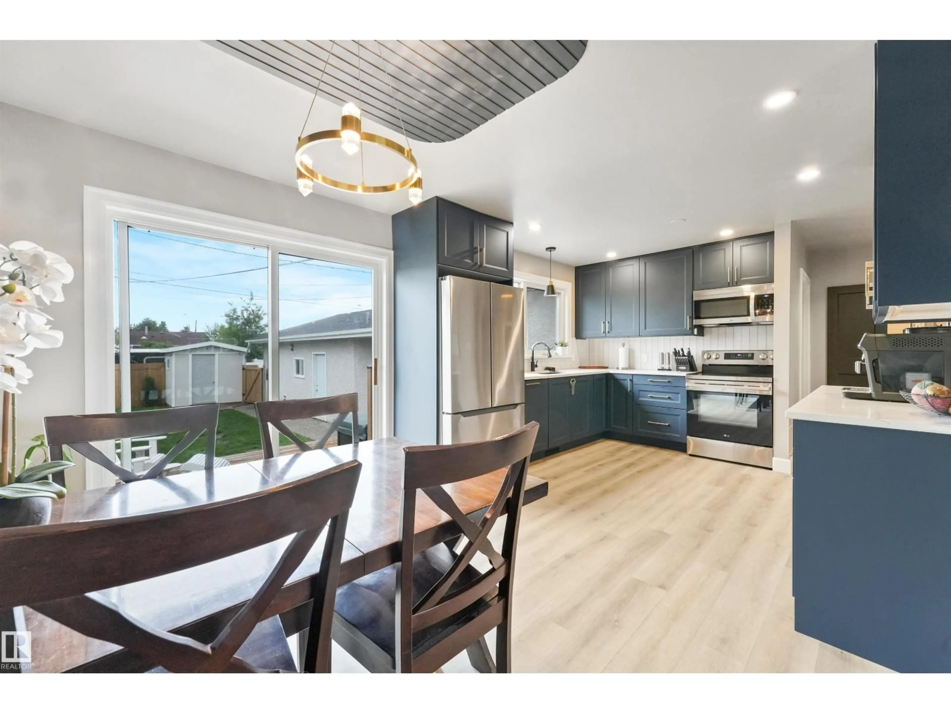 Open concept kitchen, wood/laminate floor for NW - 13427 111 ST, Edmonton Alberta T5E4Z7