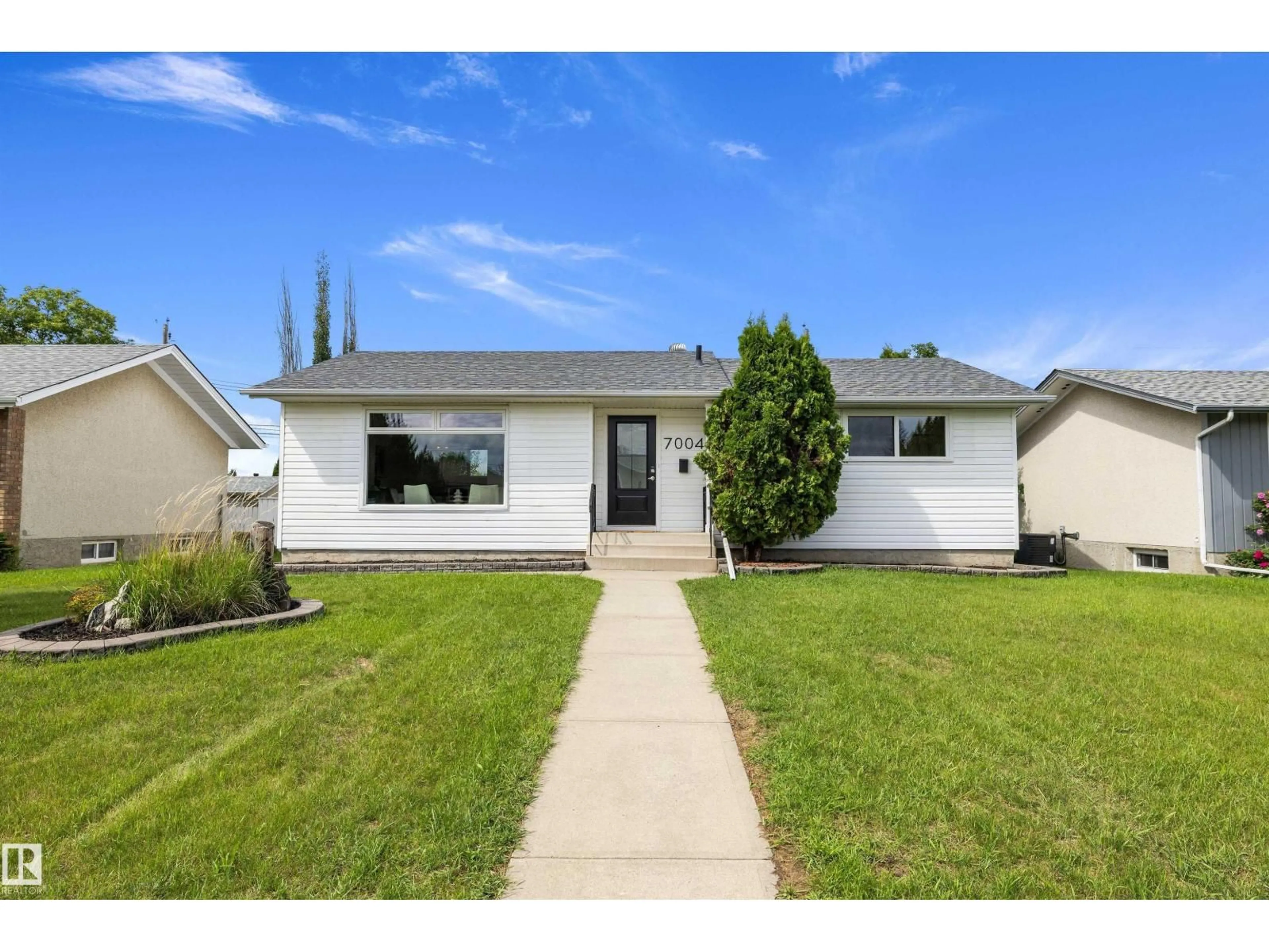 Home with vinyl exterior material, street for 7004 93 AV, Edmonton Alberta T6B0W6
