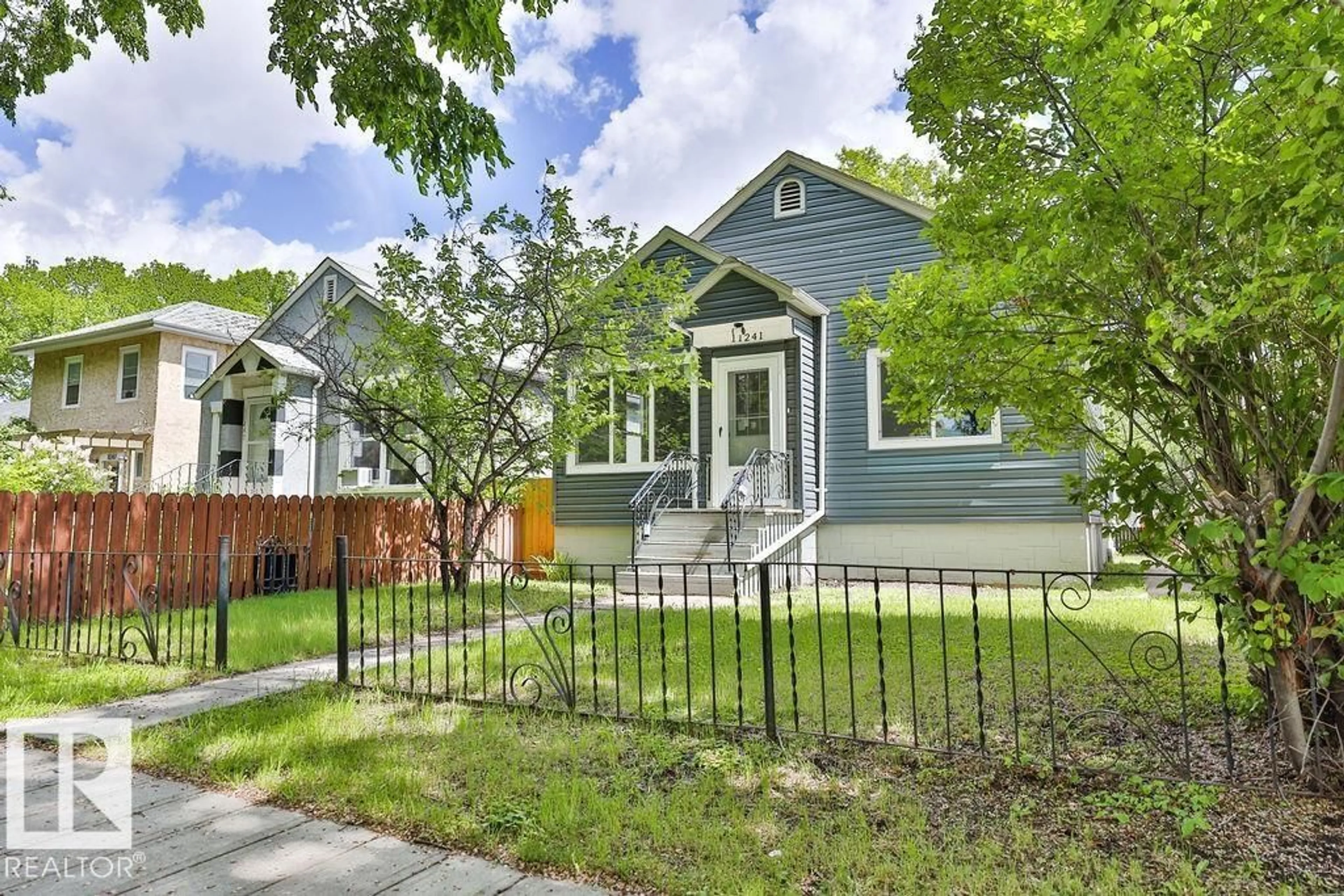 Home with vinyl exterior material, street for 11241 88 ST, Edmonton Alberta T5B3P6