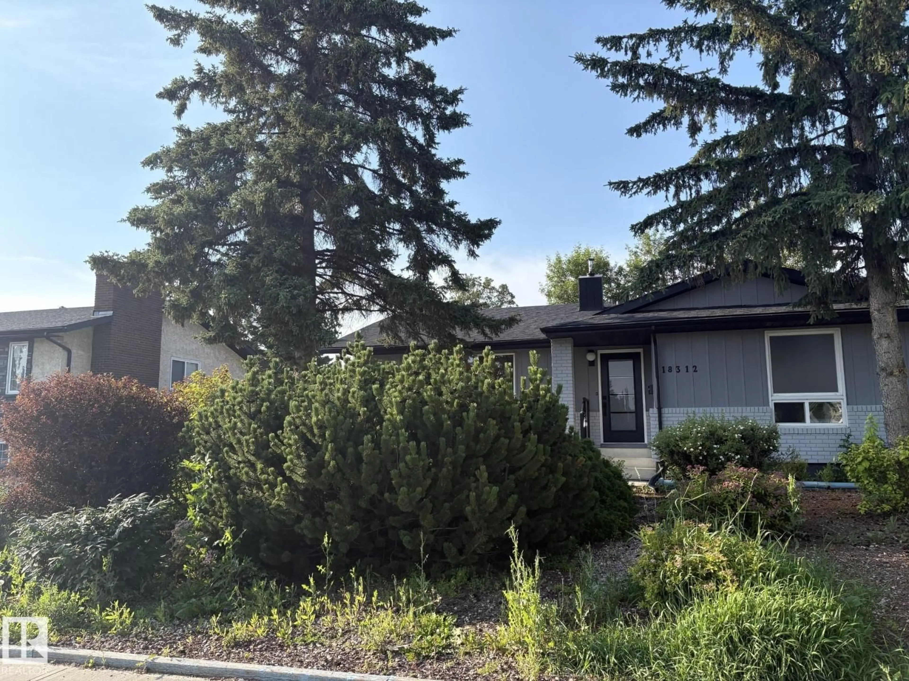 Home with vinyl exterior material, street for 18312 91 AV, Edmonton Alberta T5T1N9