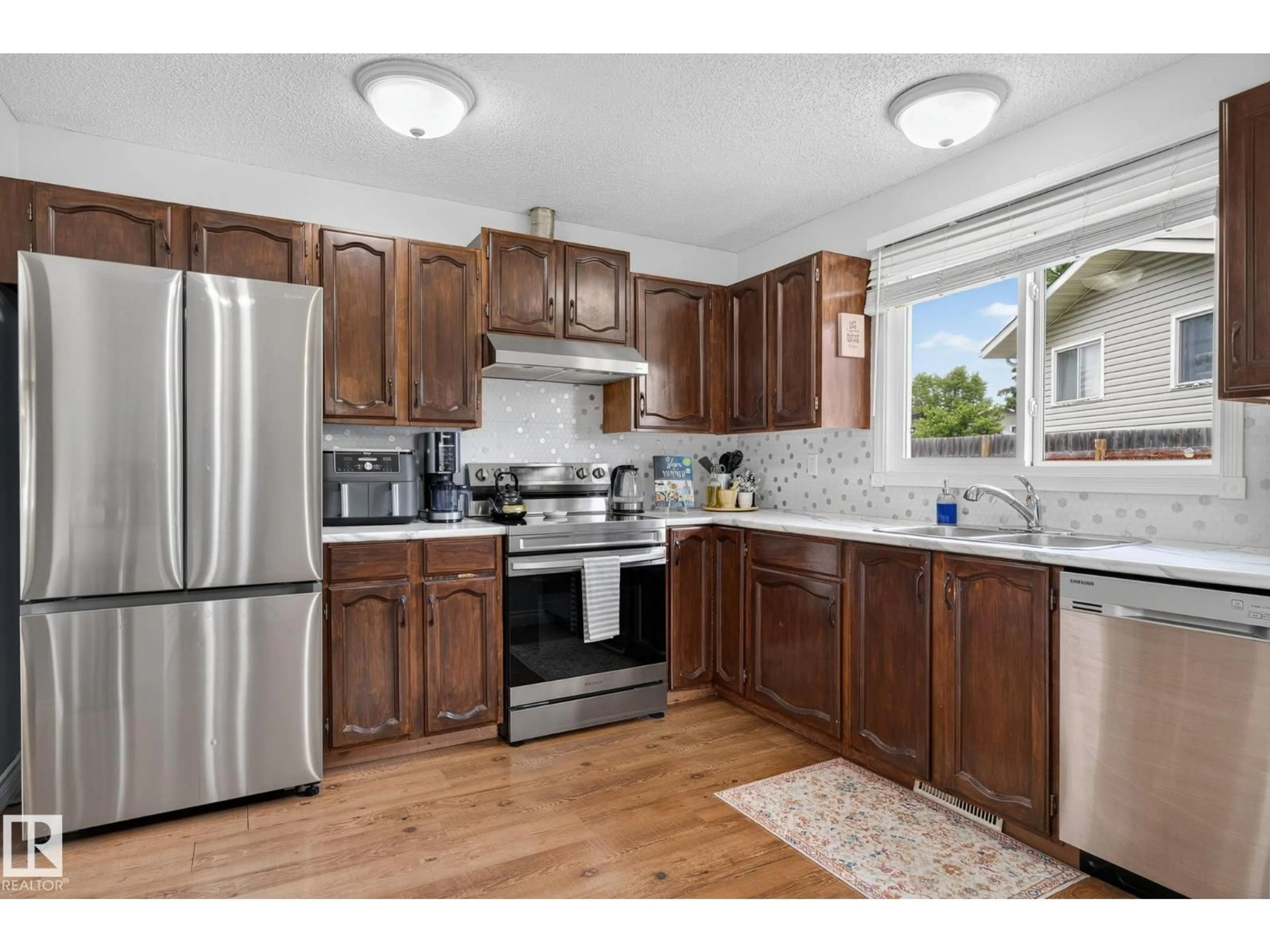 Open concept kitchen, wood/laminate floor for NW NW - 14612 29 ST, Edmonton Alberta T5Y2A3
