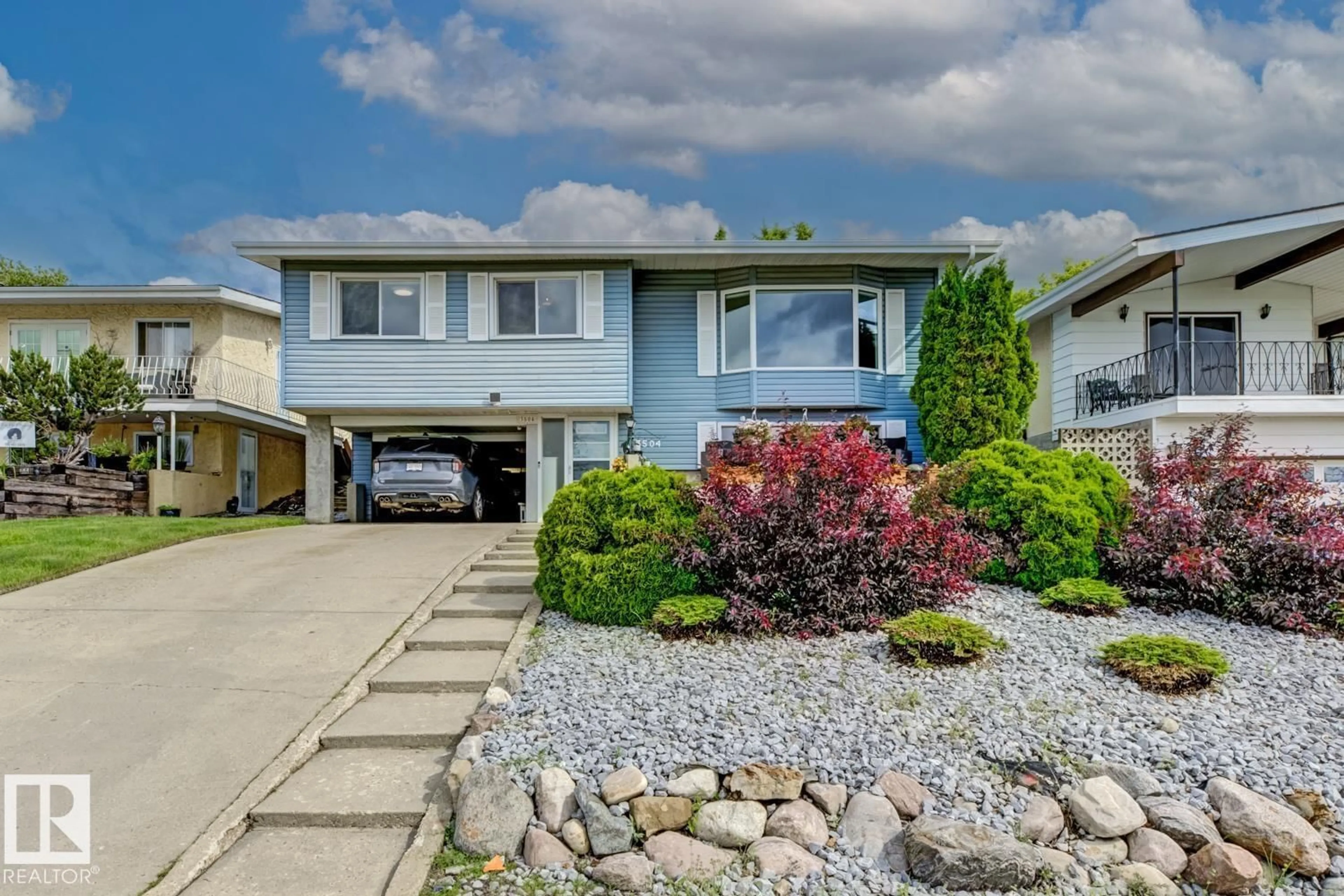 Home with vinyl exterior material, street for 3504 102 AV, Edmonton Alberta T5W0A3