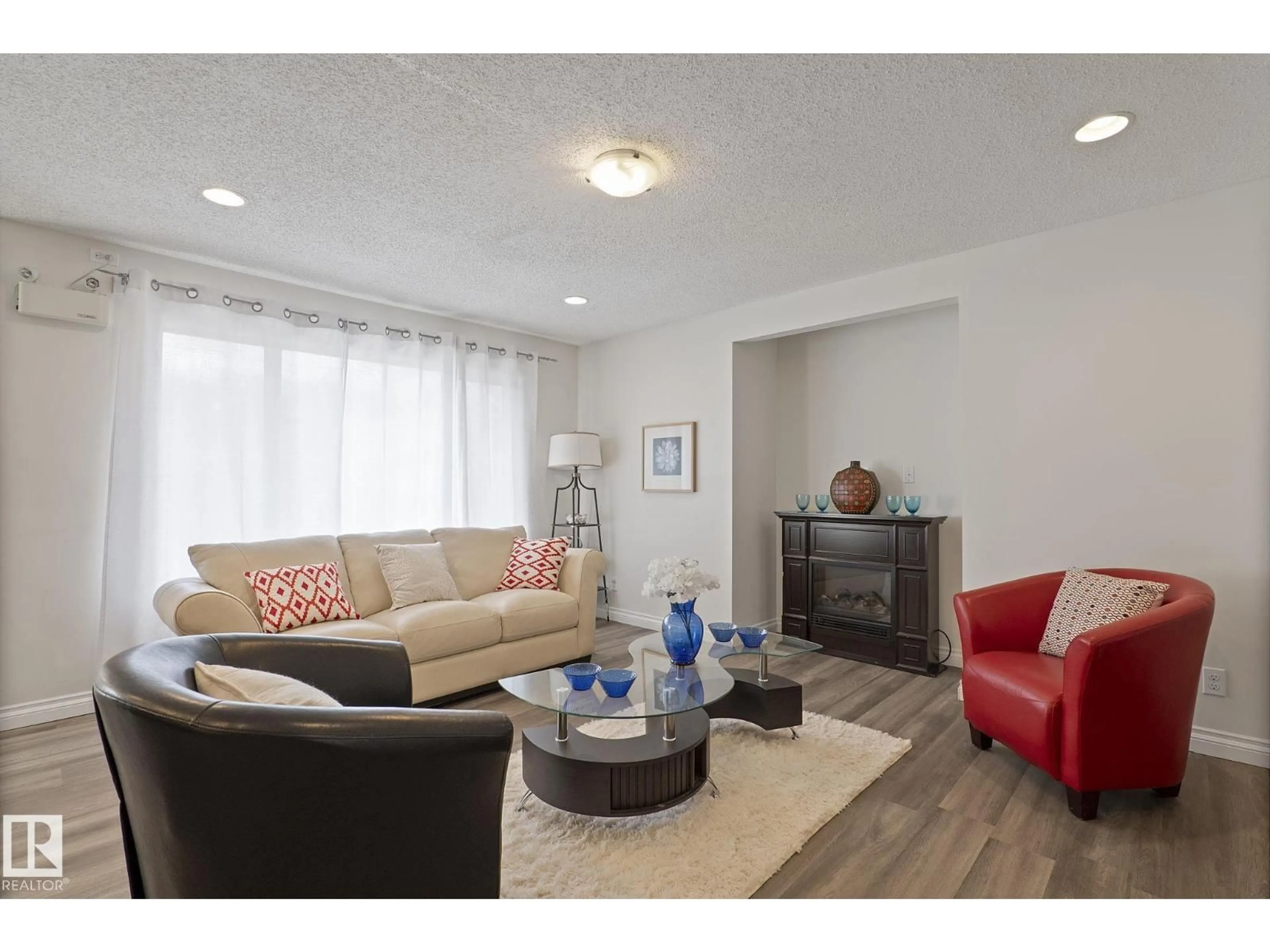 Living room with furniture, wood/laminate floor for 11918 68 ST NW, Edmonton Alberta T5B1P7