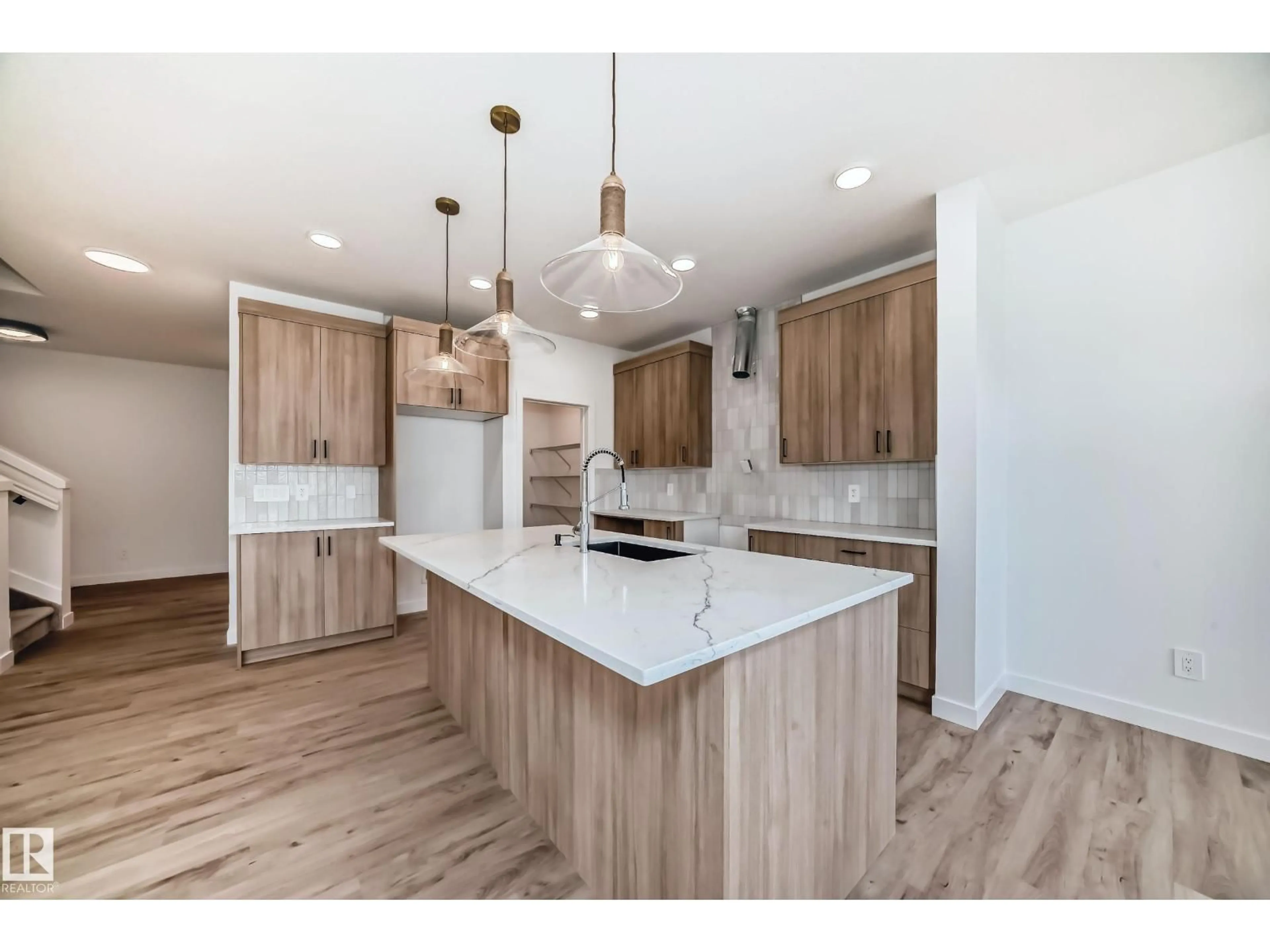 Open concept kitchen, wood/laminate floor for SW - 8255 KIRIAK LO, Edmonton Alberta T6W5S2