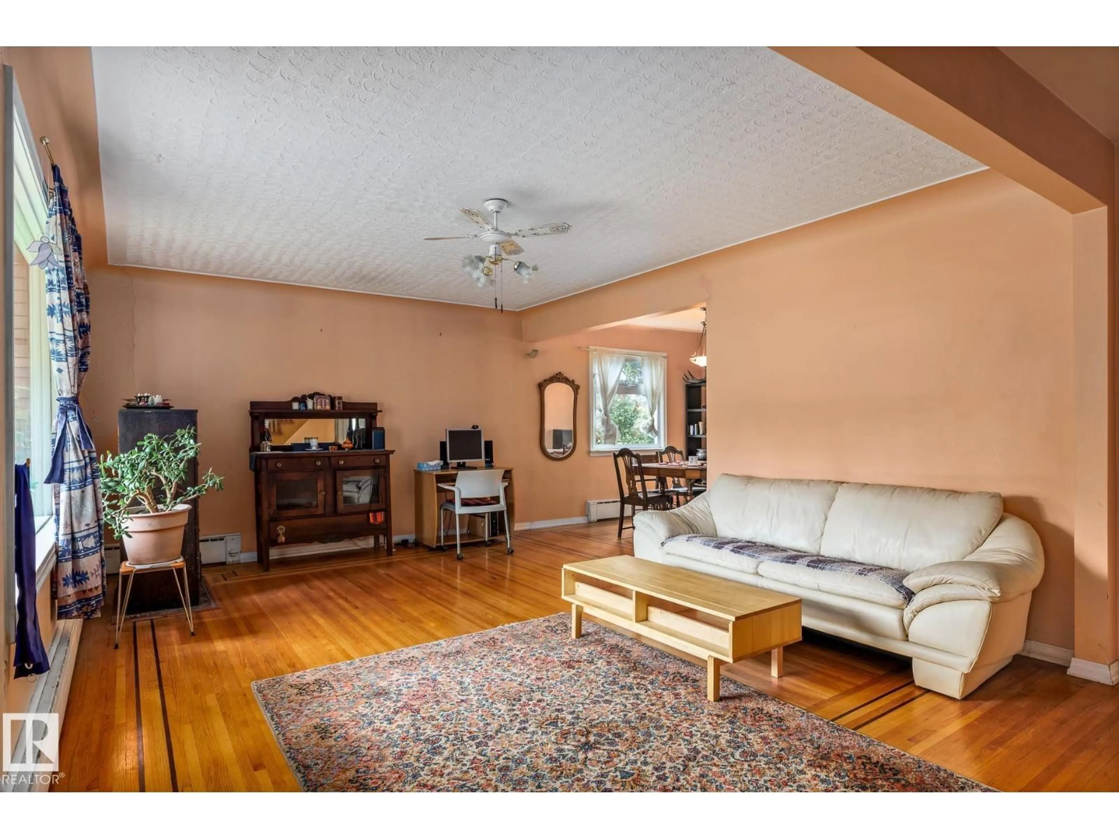 Living room with furniture, wood/laminate floor for 11022 110 AV, Edmonton Alberta T5H1H9
