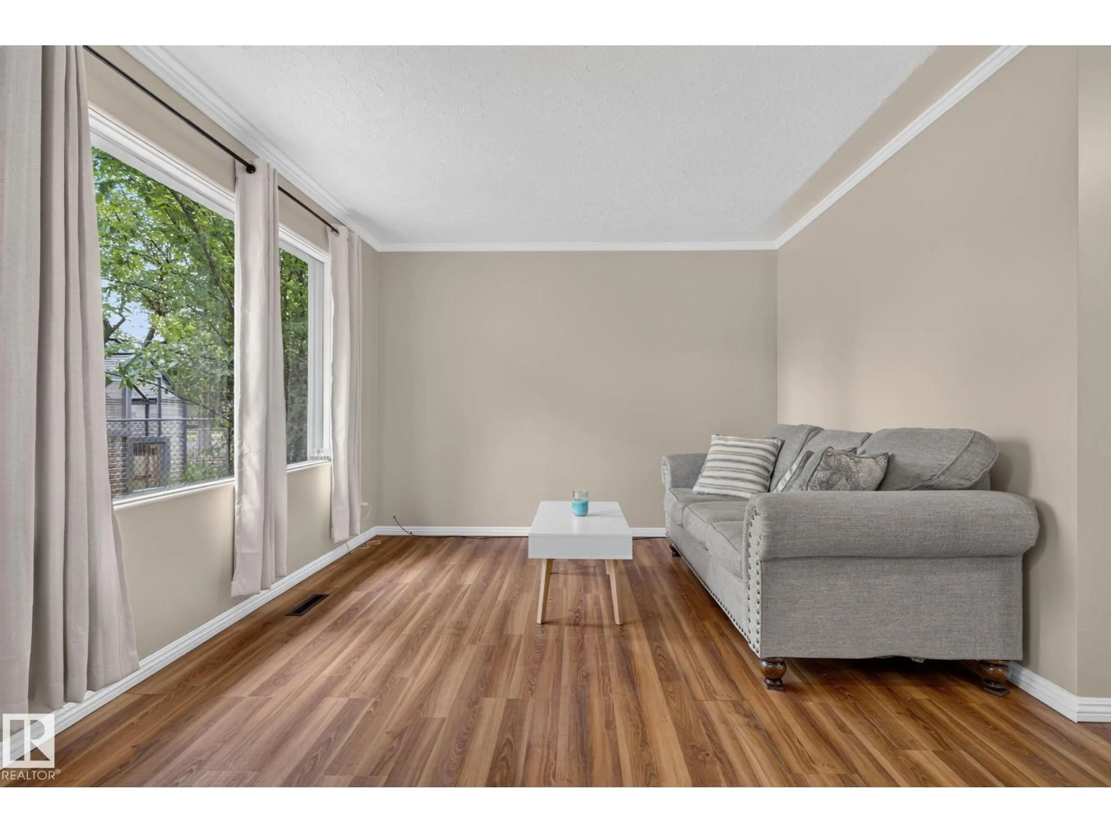 Living room with furniture, wood/laminate floor for NW - 12952 114 ST, Edmonton Alberta T5E5C8