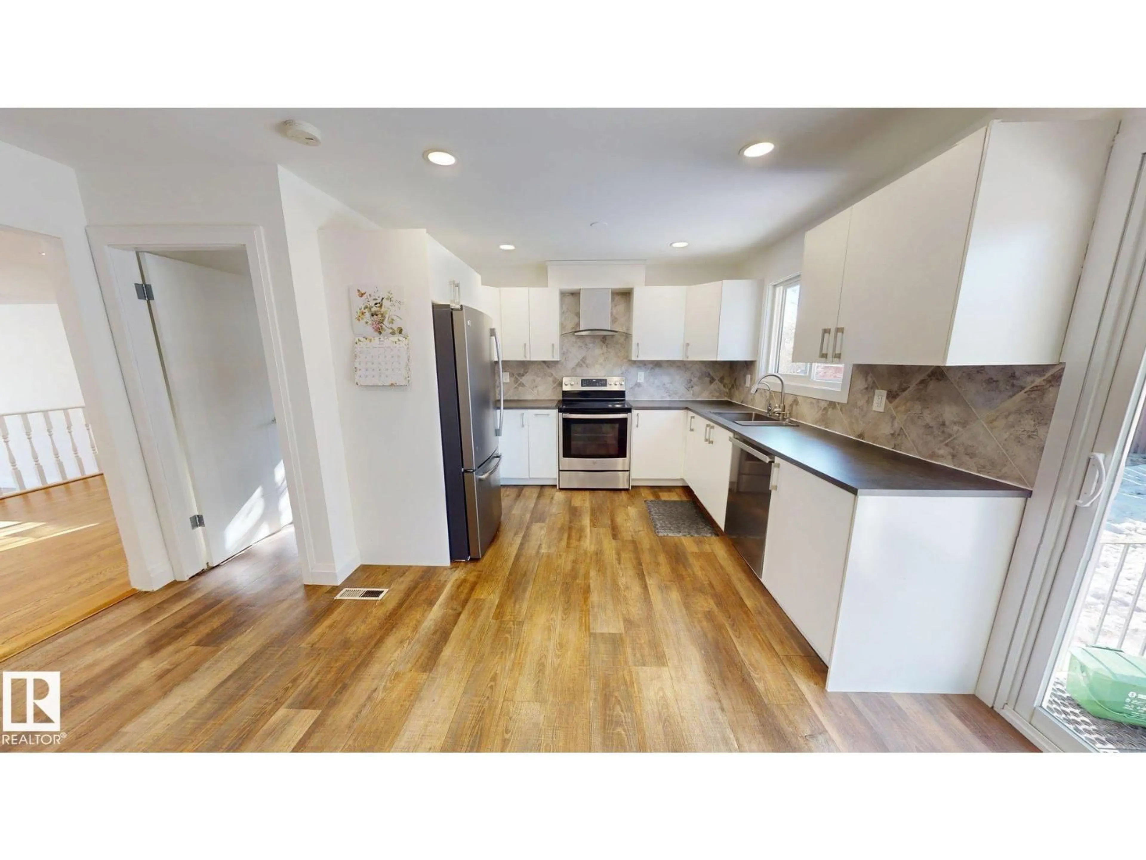 Open concept kitchen, wood/laminate floor for NW - 3718 103B ST, Edmonton Alberta T6J2X9