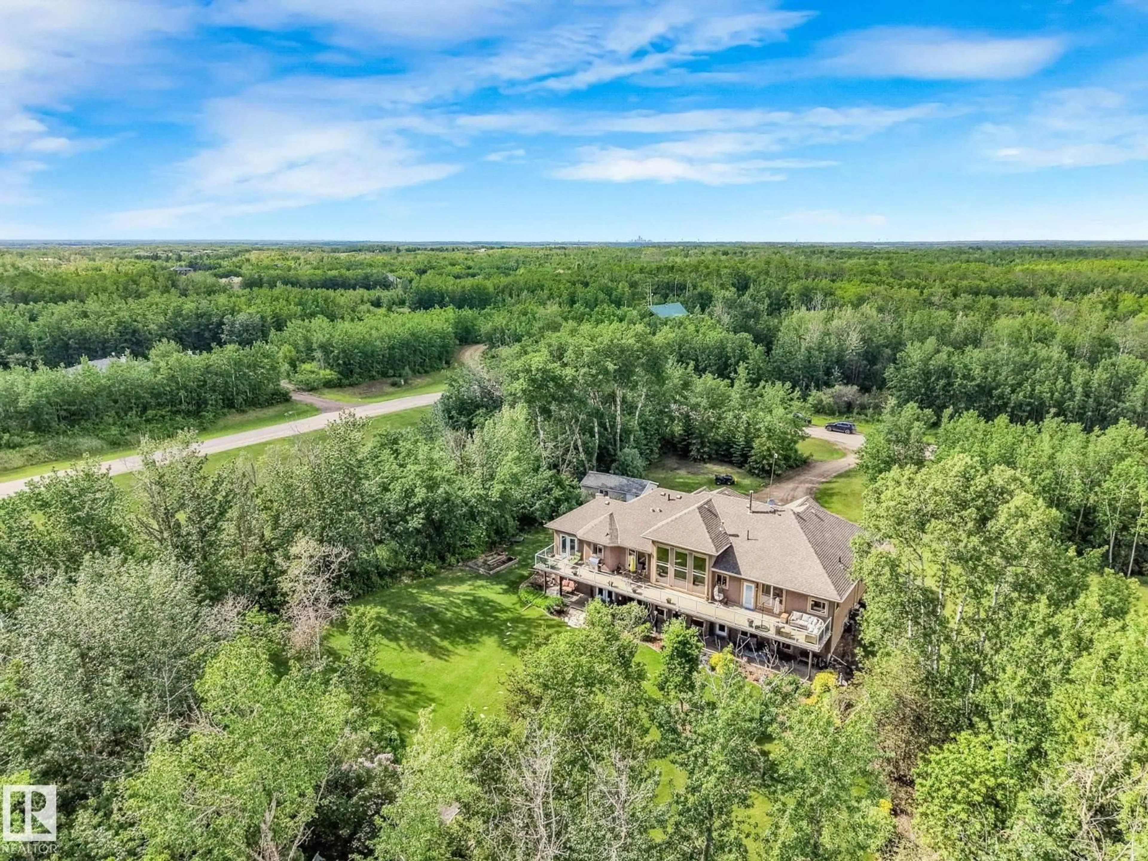 A pic from outside/outdoor area/front of a property/back of a property/a pic from drone, water/lake/river/ocean view for 160 50446 RGE RD 232, Rural Leduc County Alberta T4X0L1